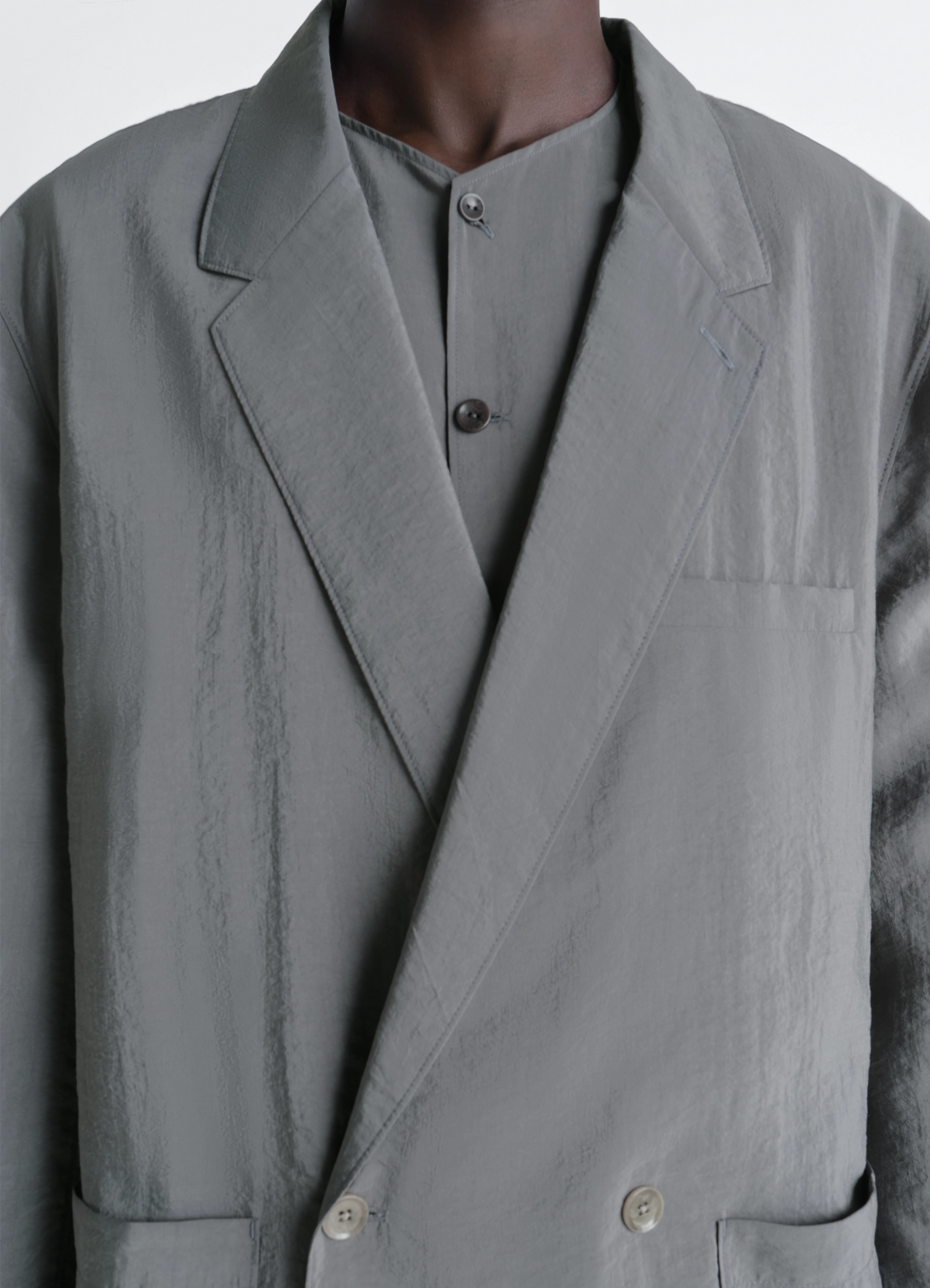 Soft double breasted jacket in dry silk, model shot, close-up detail textured fabric, lapel