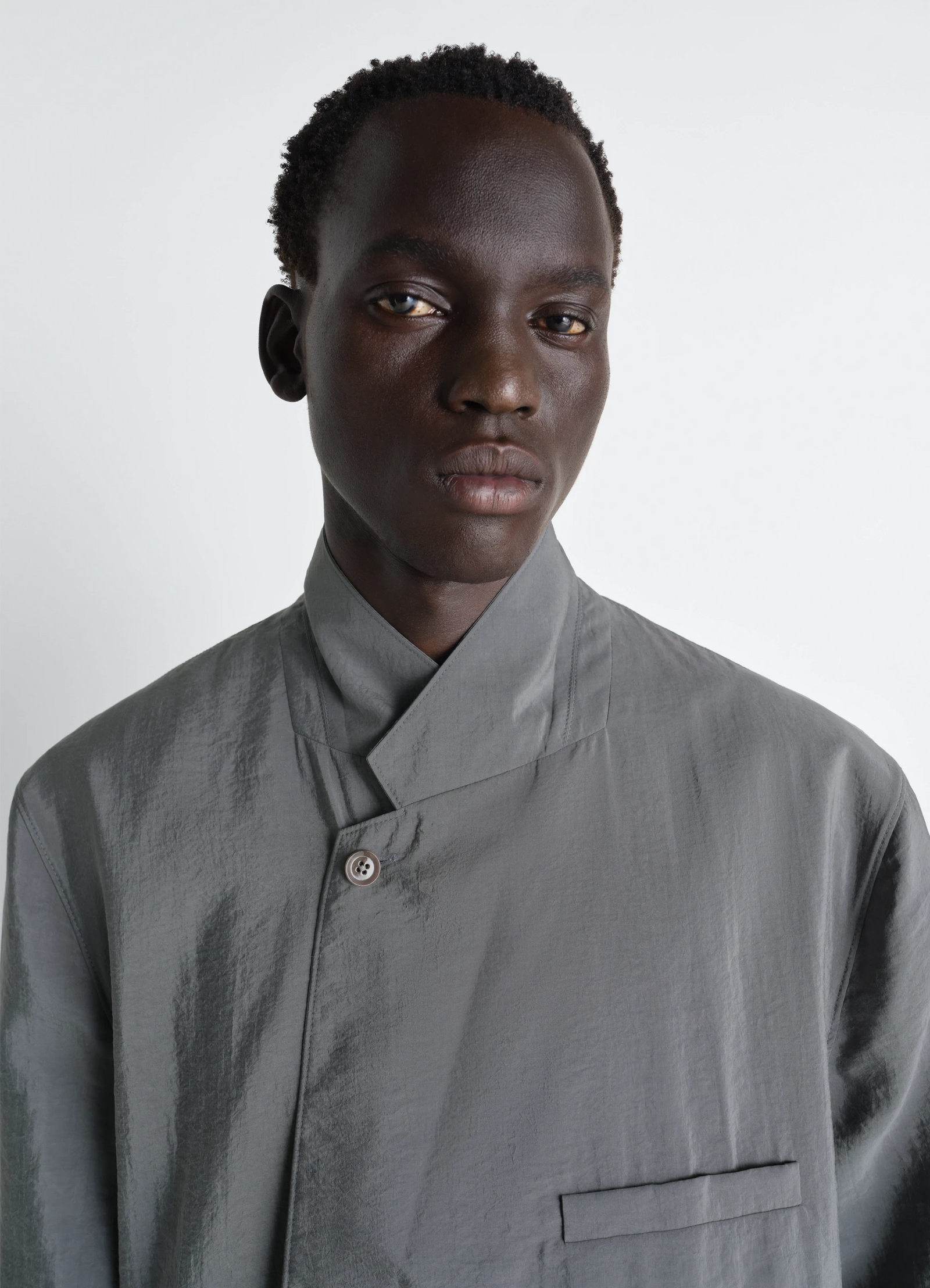 Soft double breasted jacket in dry silk, model shot, close-up upper body minimalistic collar
