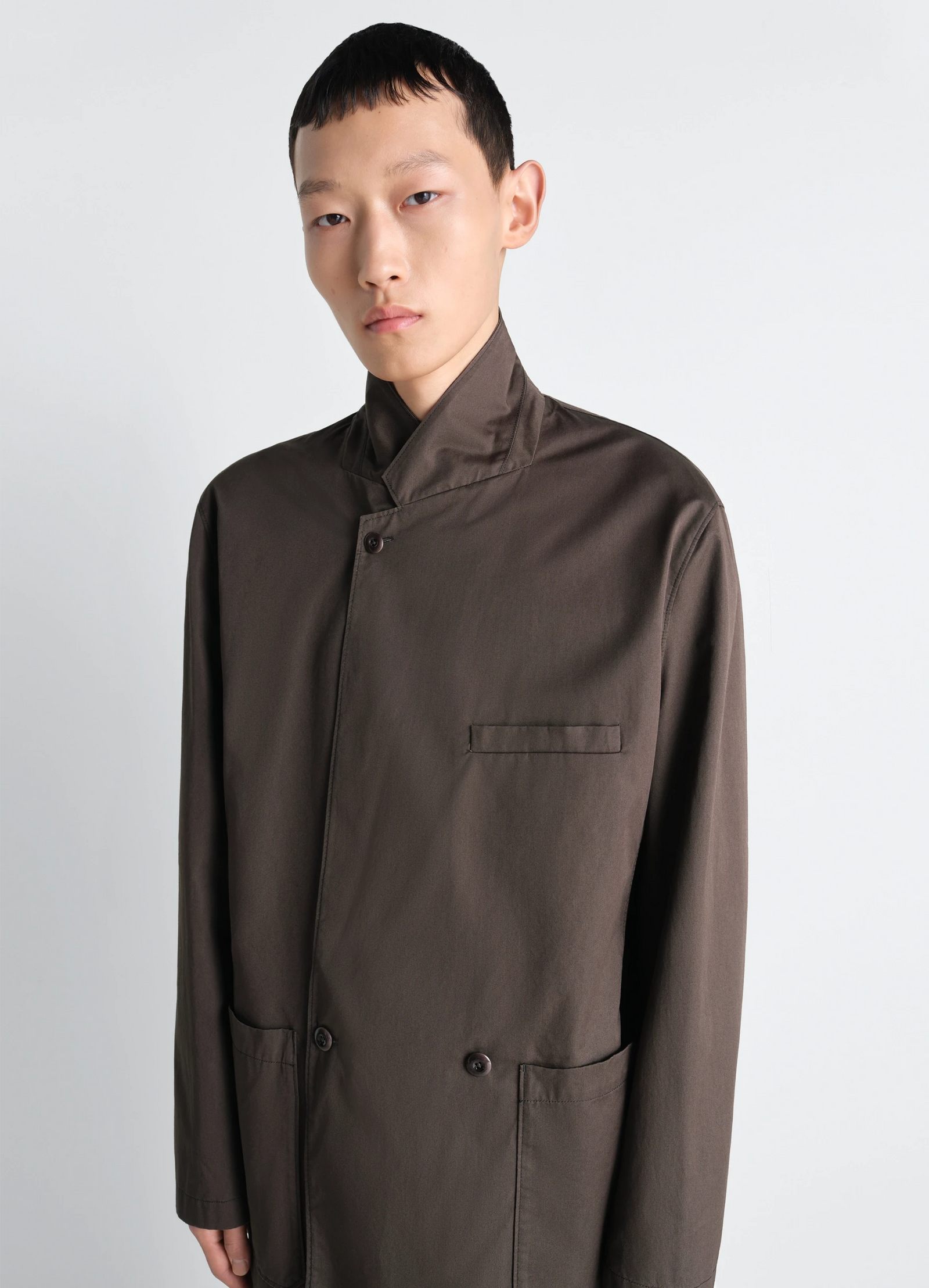 Double breasted workwear jacket in cotton twill, model shot, three-quarter view high collar, chest pocket