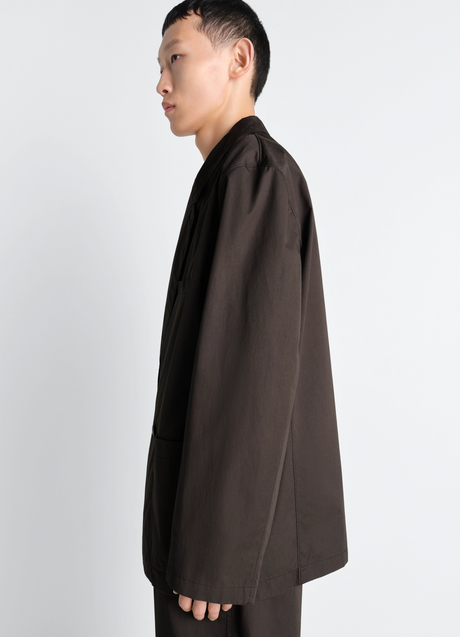 Double breasted workwear jacket in cotton twill, model shot, side view long sleeve profile