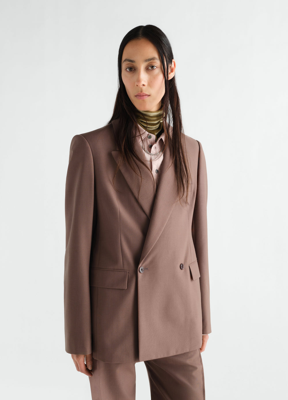 Double-breasted tailored wool blend jacket in brown by LEMAIRE worn by a model front view