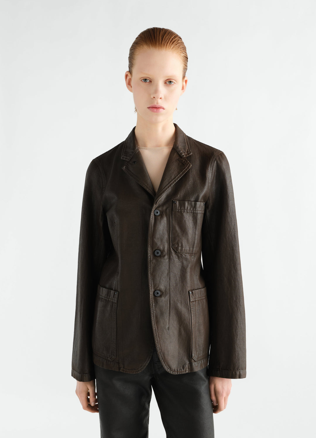 Workwear tailored jacket in dark brown coated broken twill by LEMAIRE worn by a model front view