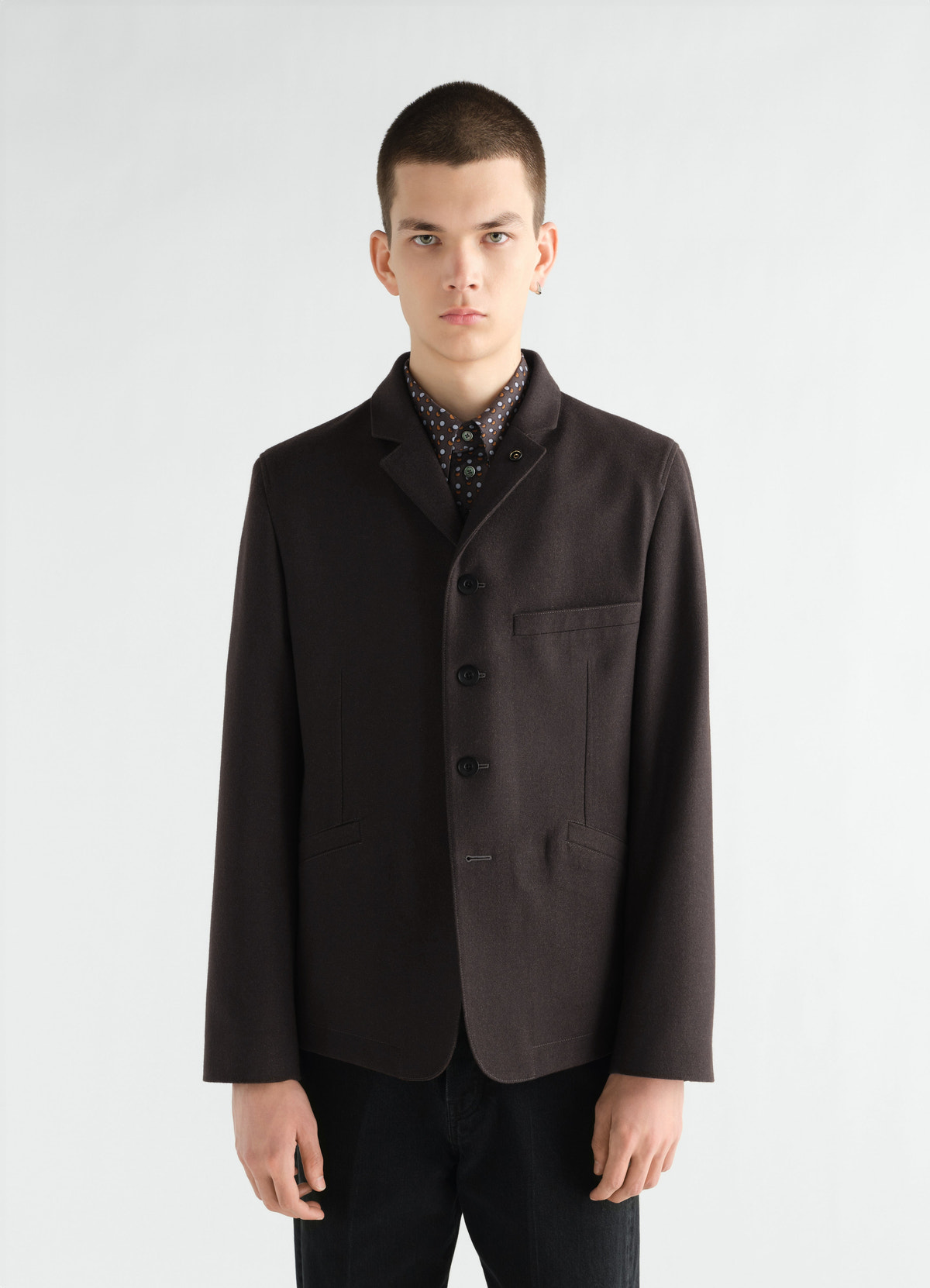 Utility tailored wool and cotton twill jacket in dark brown worn by model front view lemaire