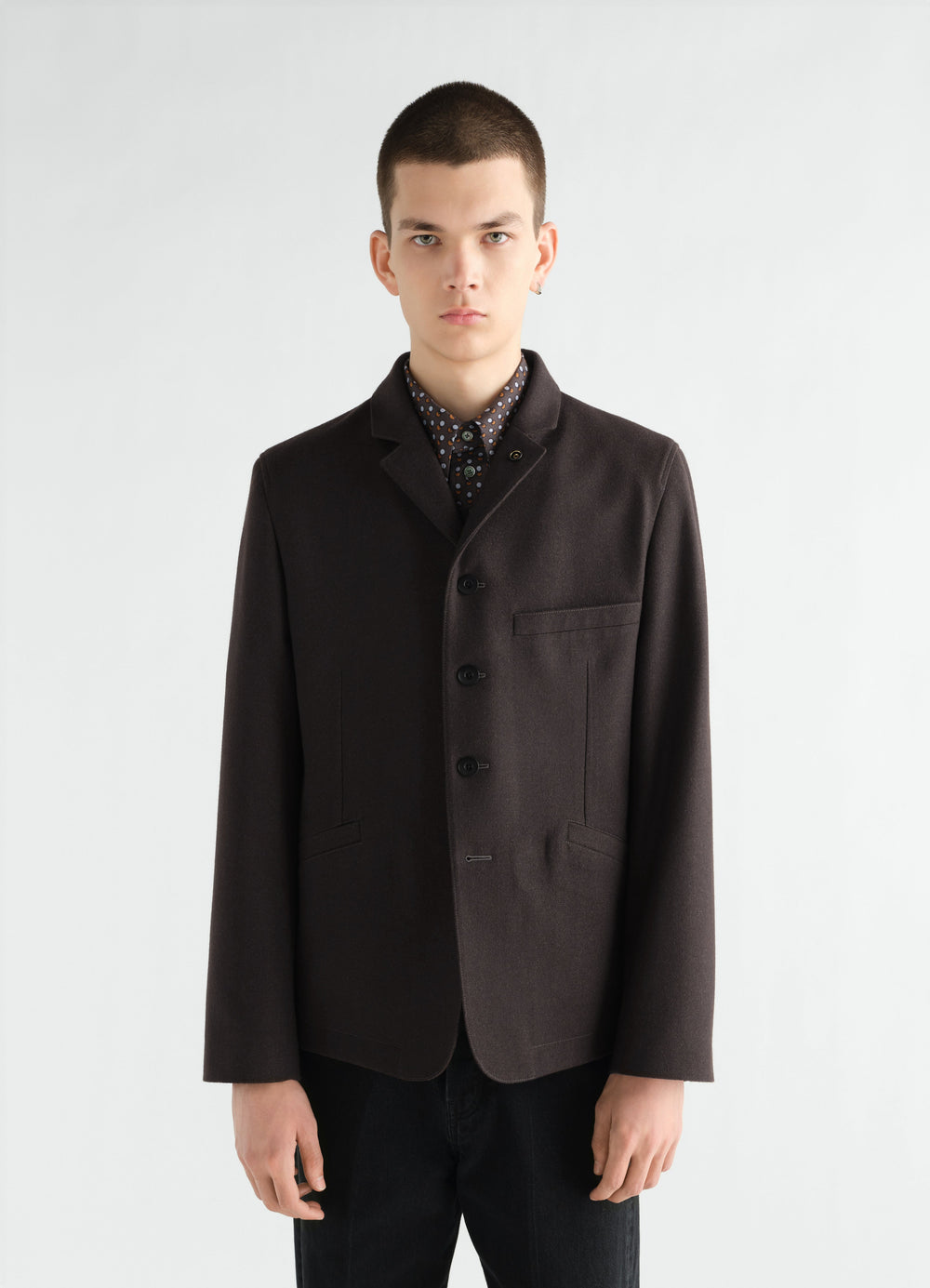 Utility tailored wool and cotton twill jacket in dark brown worn by model front view LEMAIRE