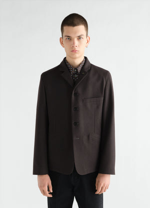 Utility tailored wool and cotton twill jacket in dark brown worn by model front view lemaire