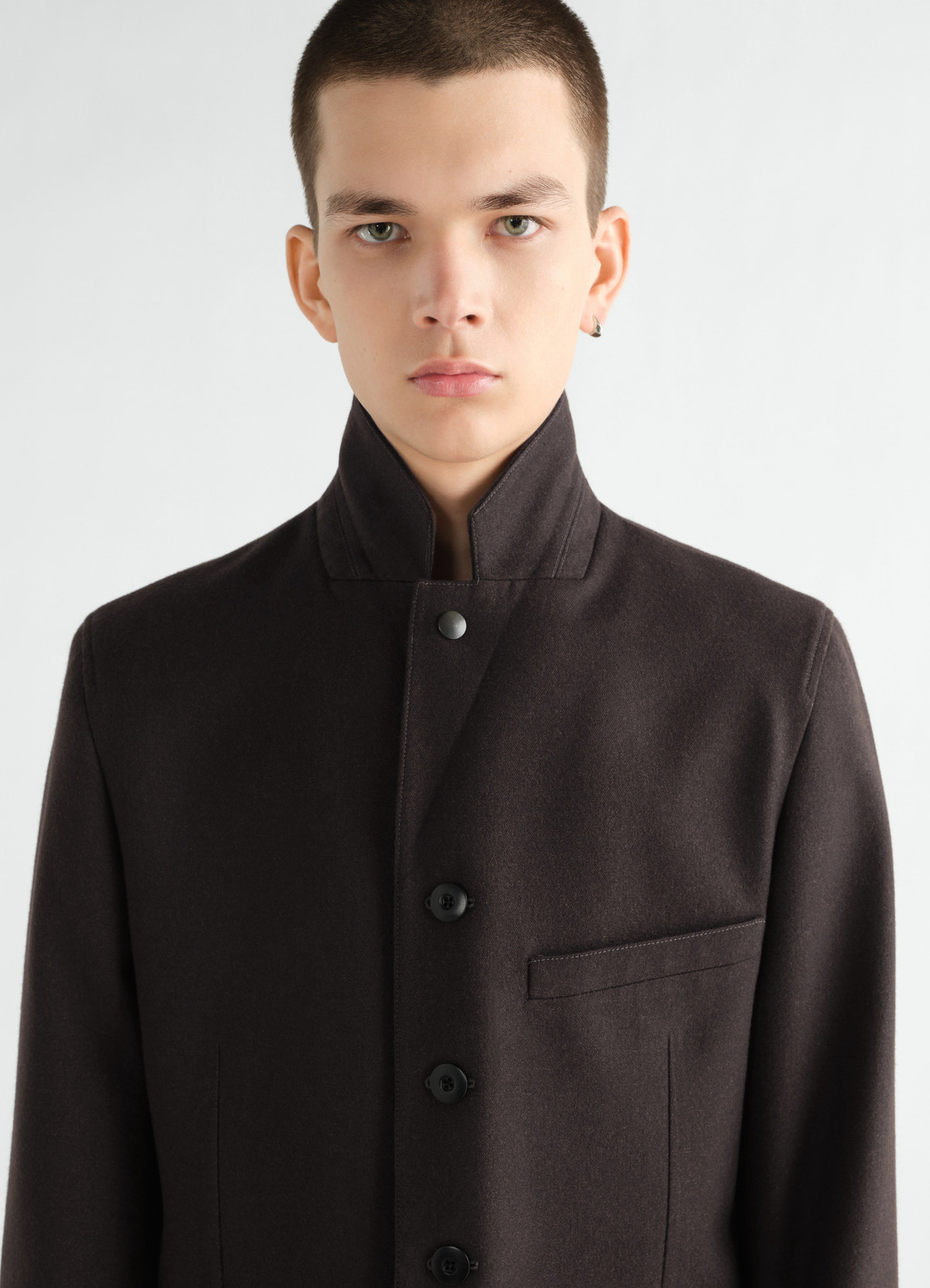 Utility tailored jacket in dark brown wool cotton twill by lemaire front close-up worn by a model