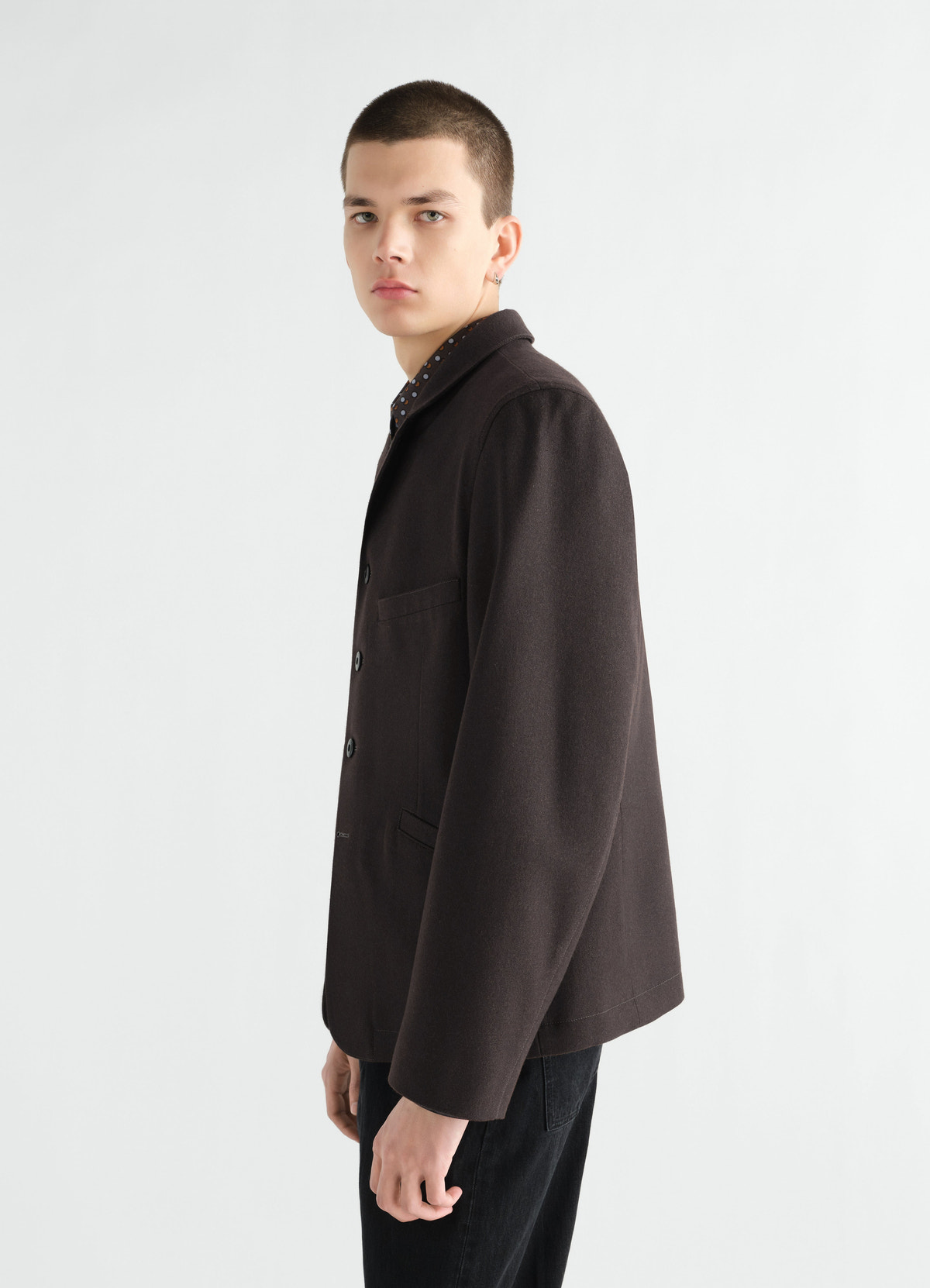 Utility tailored jacket in dark brown wool cotton twill by lemaire worn by model side view
