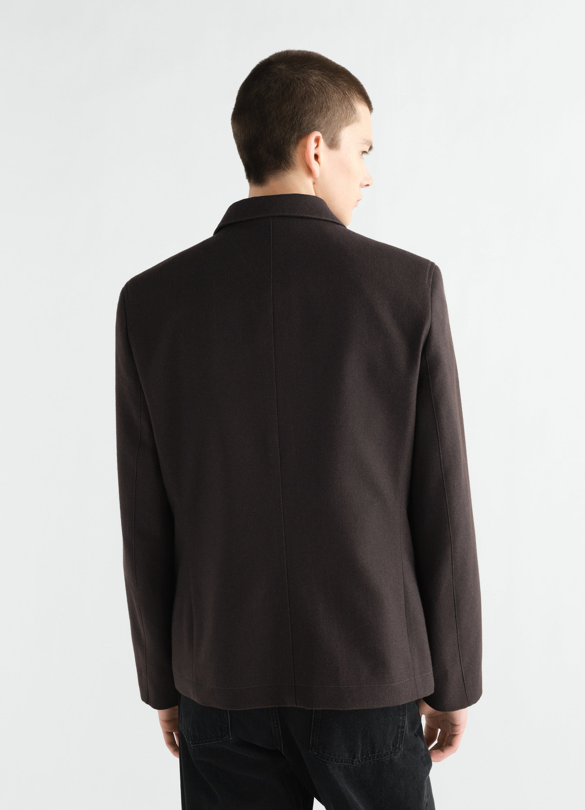 Utility tailored wool and cotton twill jacket in black worn by model back view lemaire