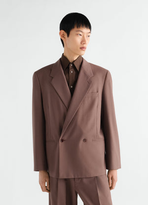 Double-breasted brown tropical wool blend jacket by lemaire worn by model front view