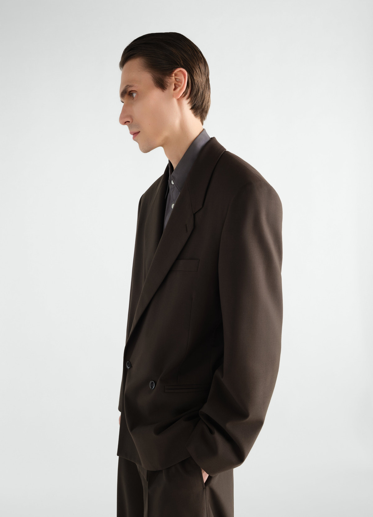 Double-breasted brown tropical wool blend jacket by lemaire worn by model side view