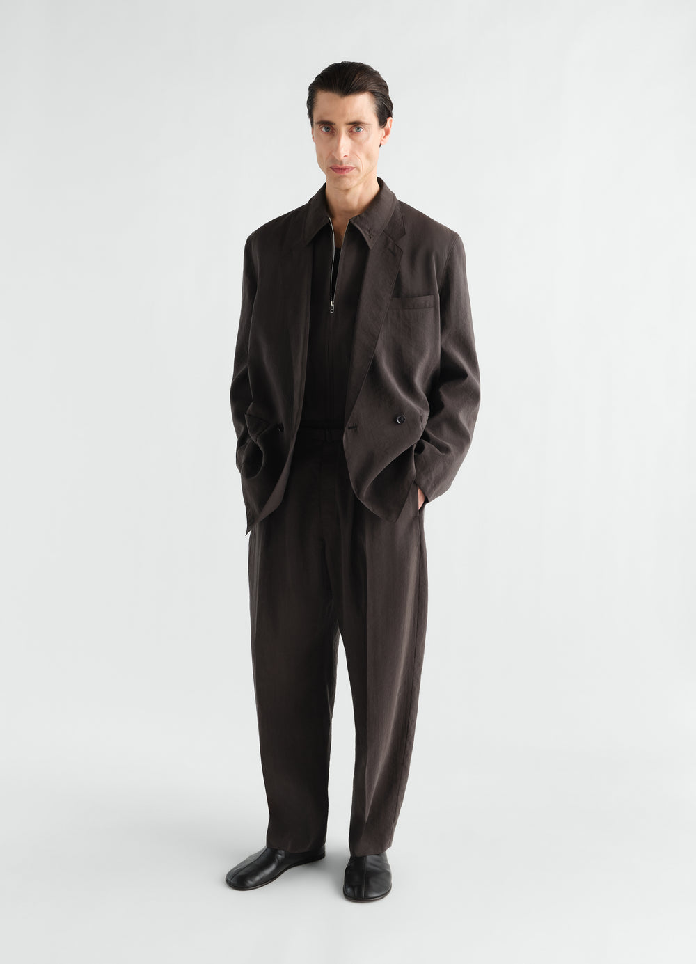 Light double-breasted silk jacket in dark brown worn by model with matching trousers LEMAIRE front view