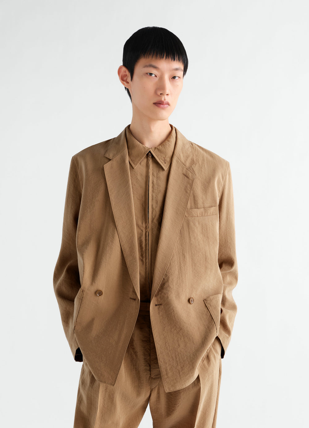 Light brown double-breasted dry silk jacket by LEMAIRE worn by model front view