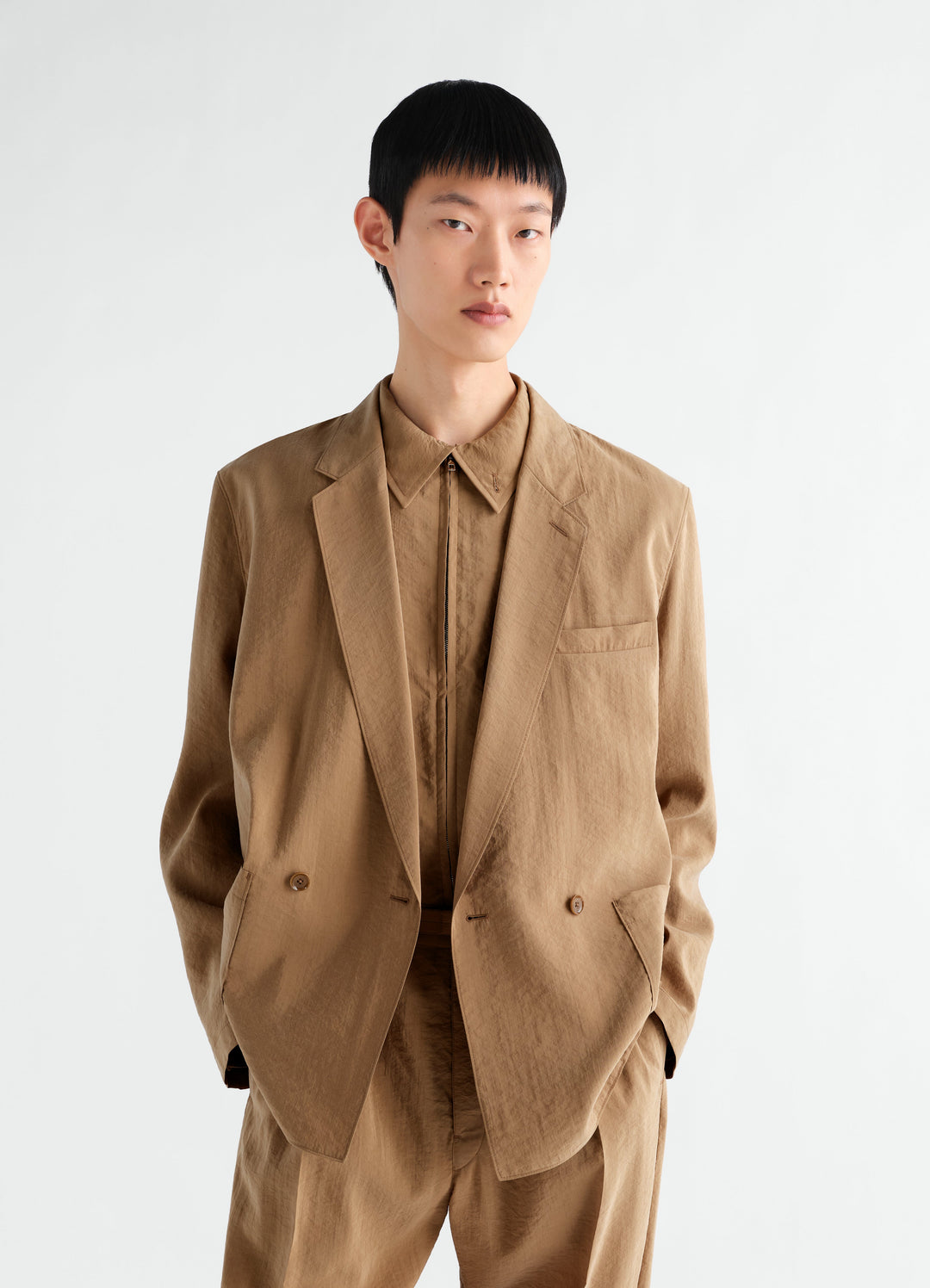 Light brown double-breasted dry silk jacket by LEMAIRE worn by model front view