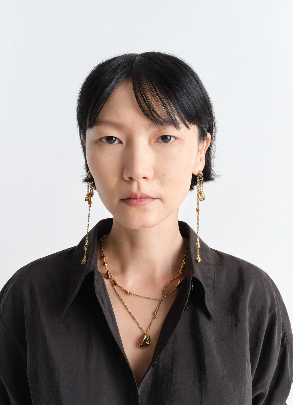 Estampe Earrings in Aged-effect Gilded Brass, model shot, three-quarter view intricate dangling chains