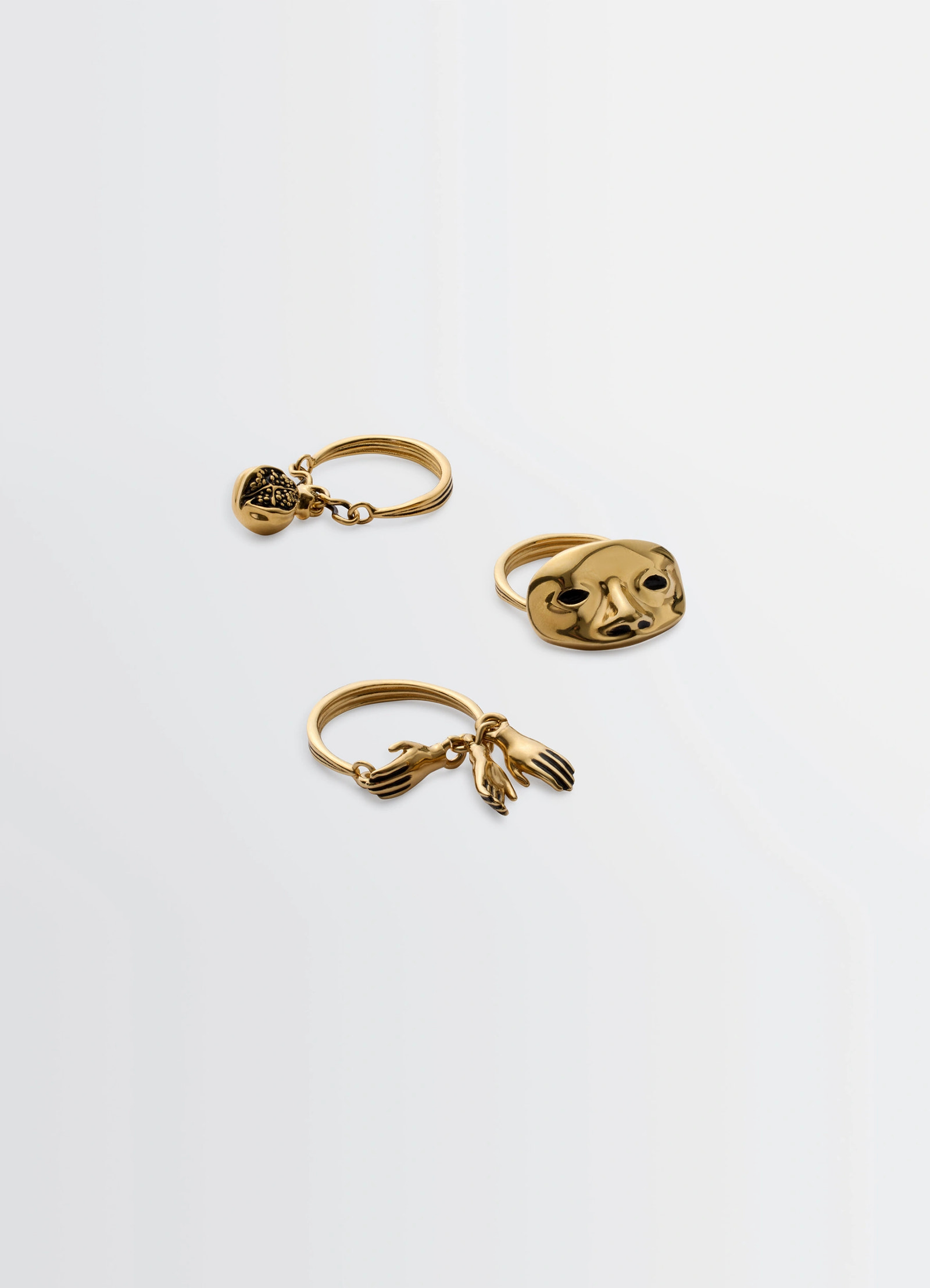 Estampe trio rings in aged-effect gilded brass, product shot, angled side view artistic charm design