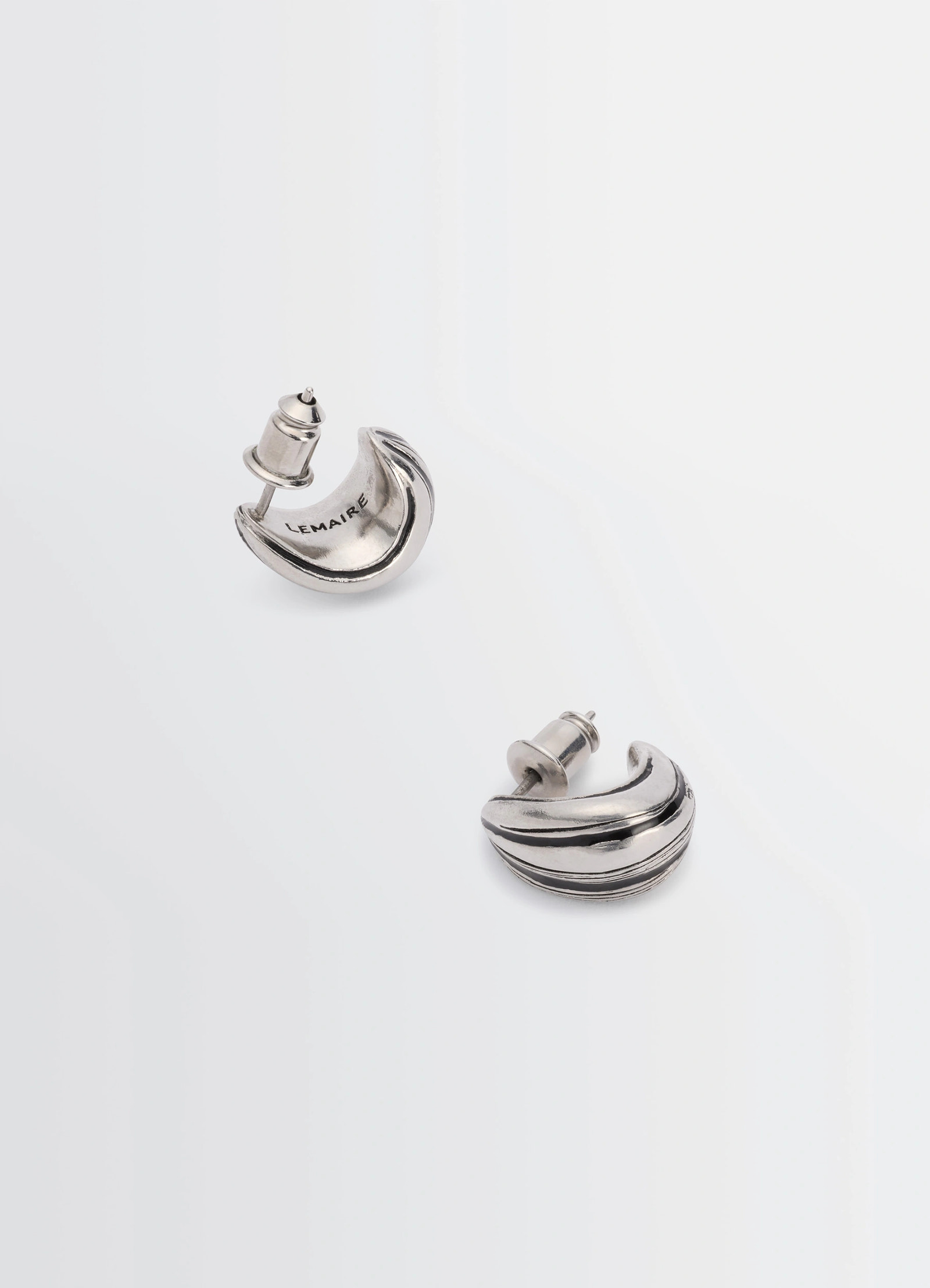 Girasol earrings in silver-plated brass, product shot, aerial view curved shape