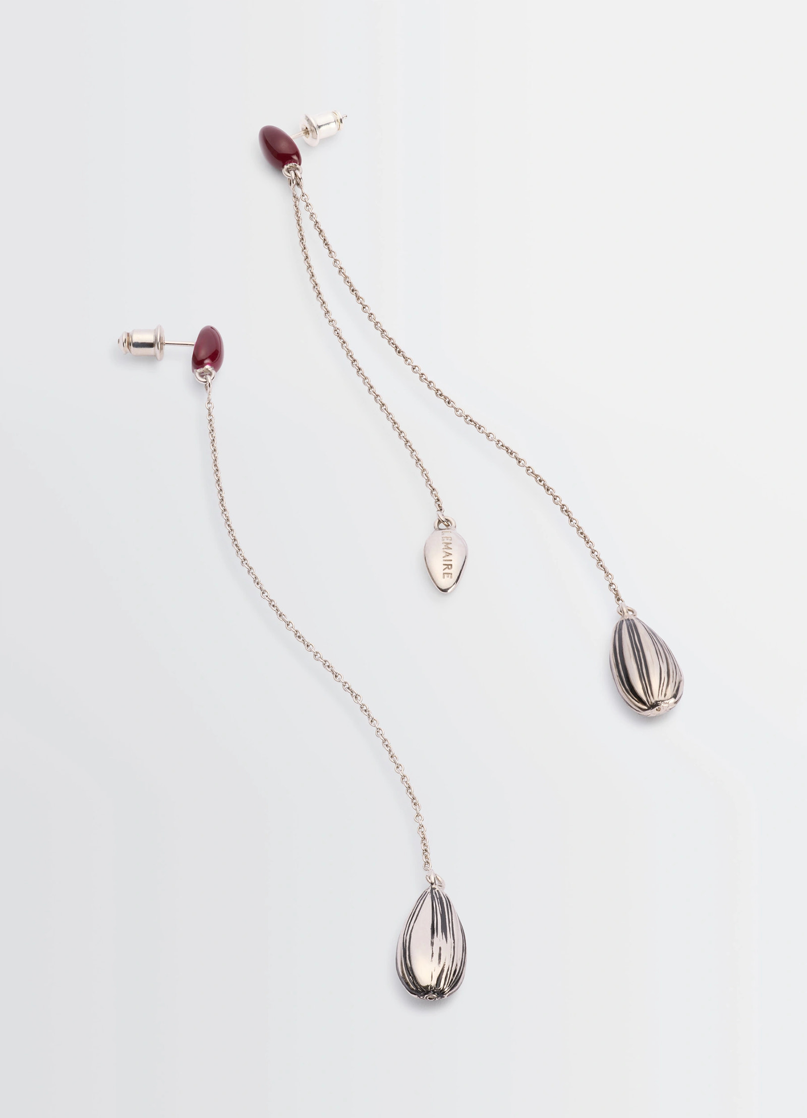 Asymmetric girasol earrings in silver-plated brass, product shot, top view teardrop accents
