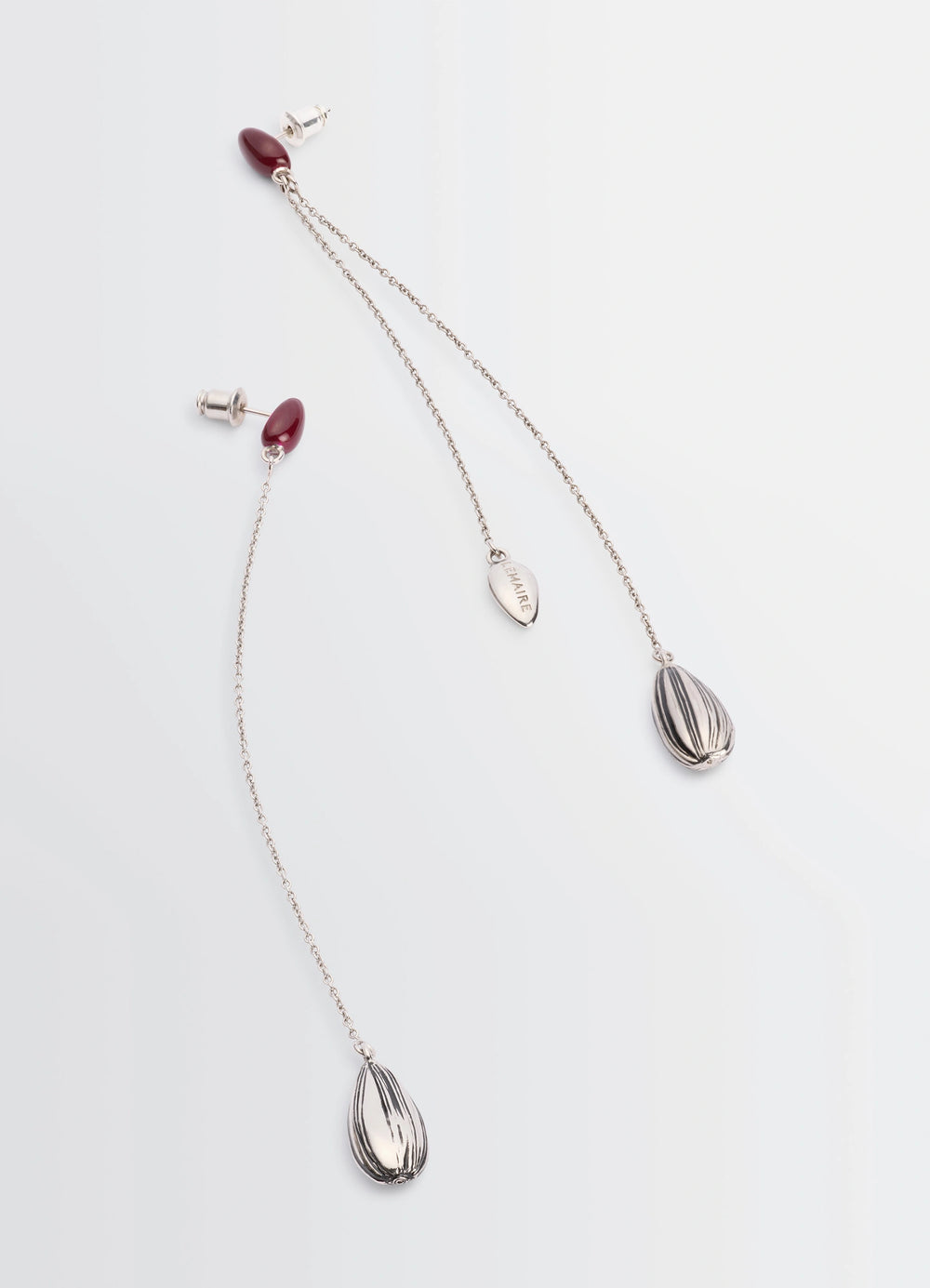 Asymmetric Girasol Earrings in Silver-plated brass, product shot, angled overhead shot striped teardrop charms