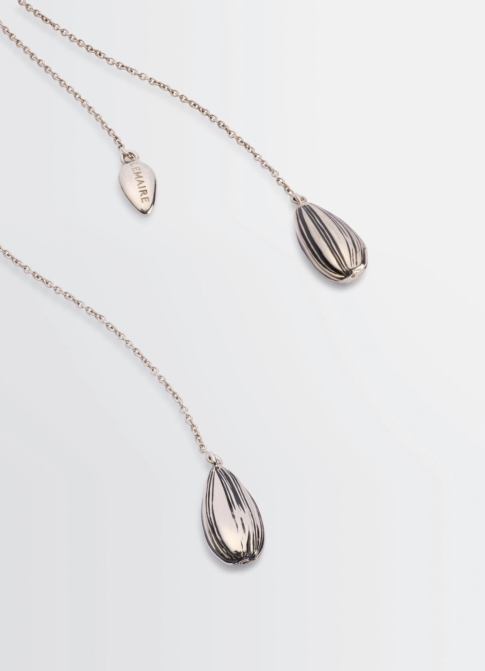 Asymmetric girasol earrings in silver-plated brass, product shot, close-up detail shot striped teardrop close-up