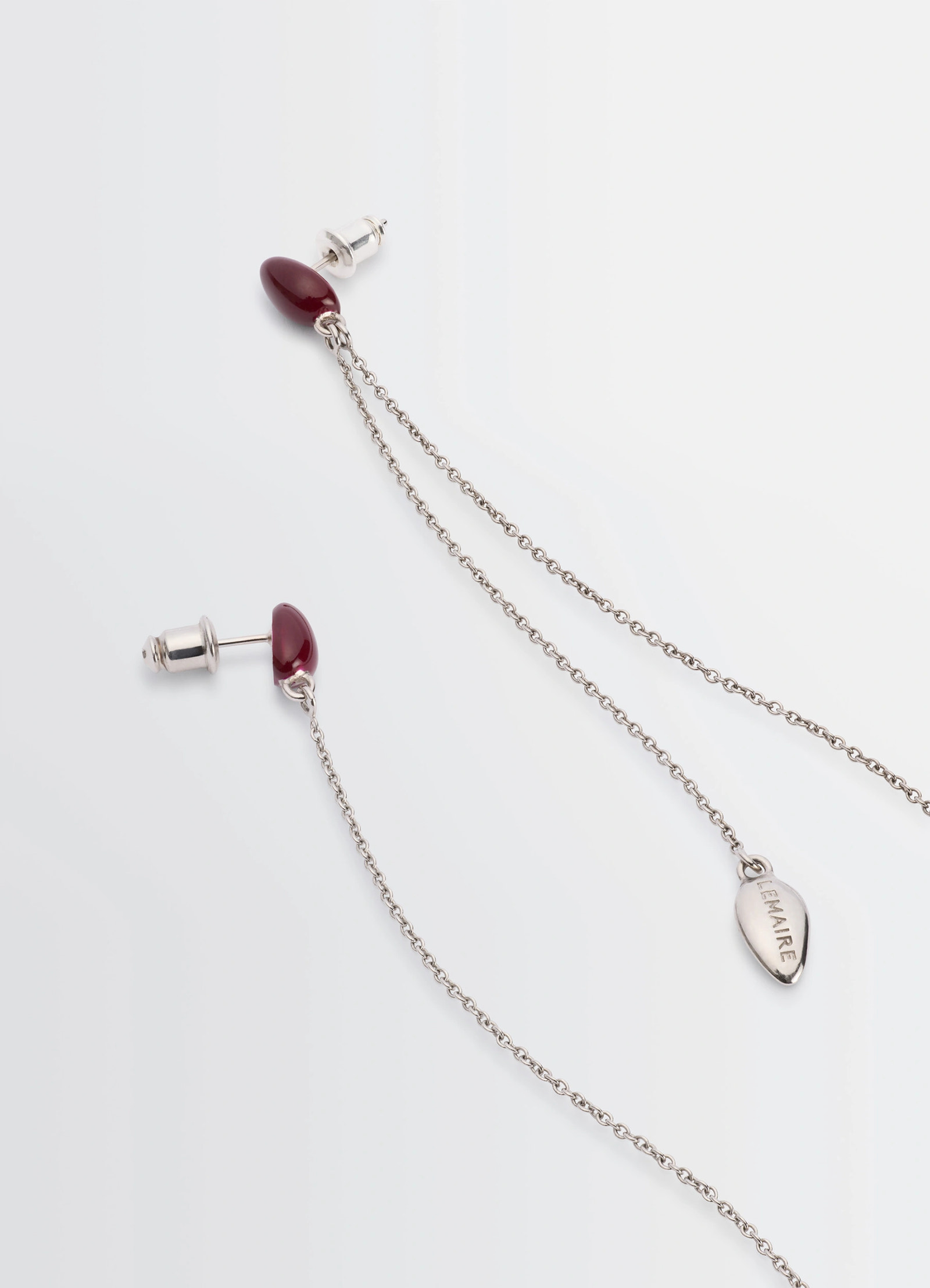 Asymetric girasol earrings in silver with red accents, product shot, top detail shot asymmetric chain design