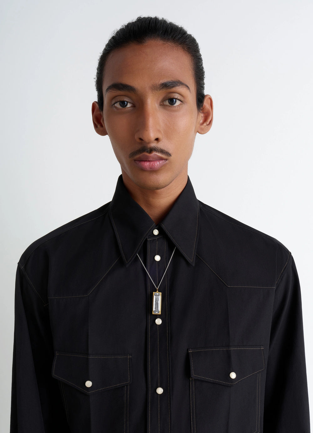 Hohner Little Lady Harmonica Neckla in Silver and Gold, model shot, neck-level close-up classic button-up shirt