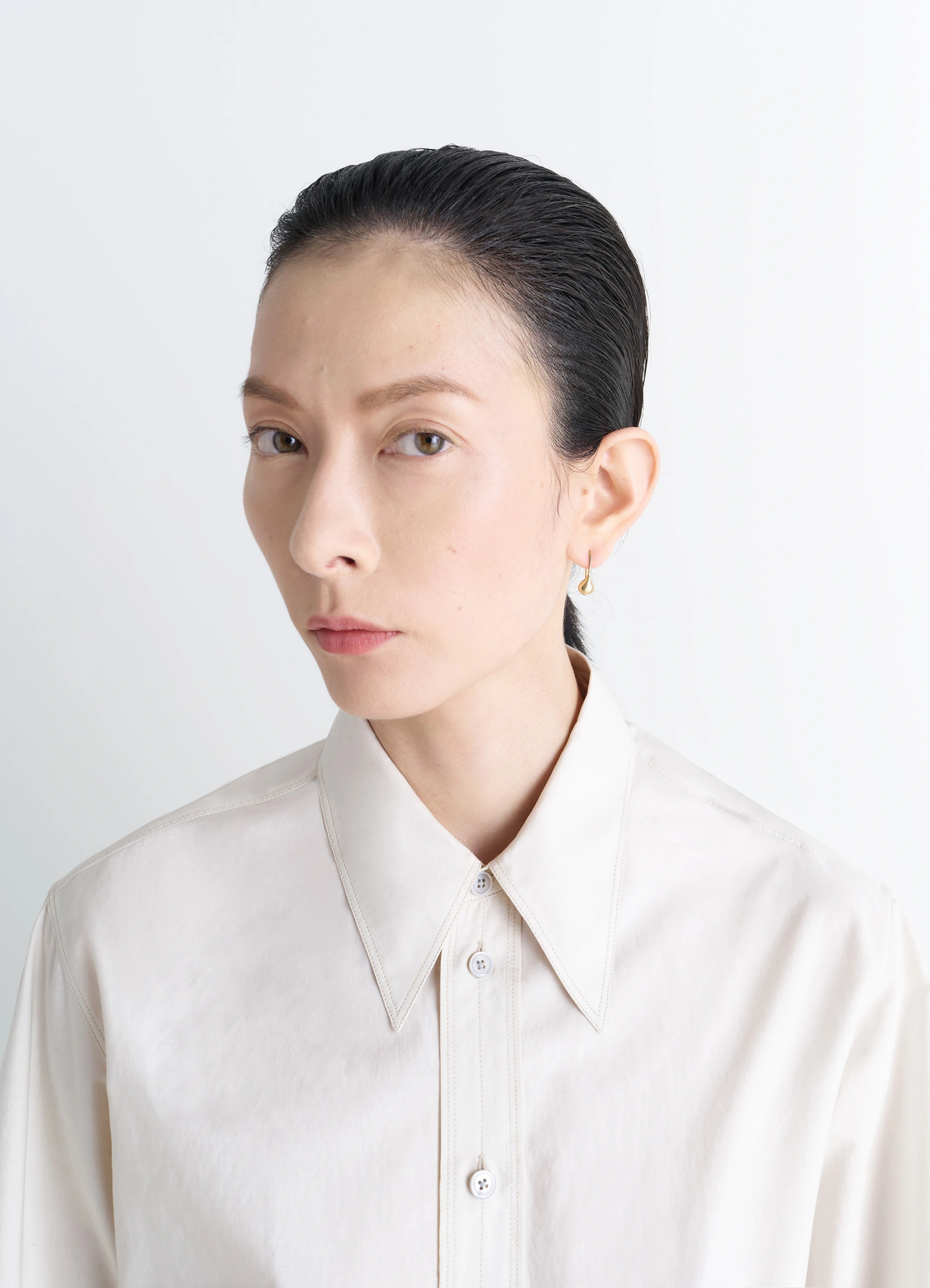 Piercings set in gold-plated silver and resin, model shot, side profile view single loop design