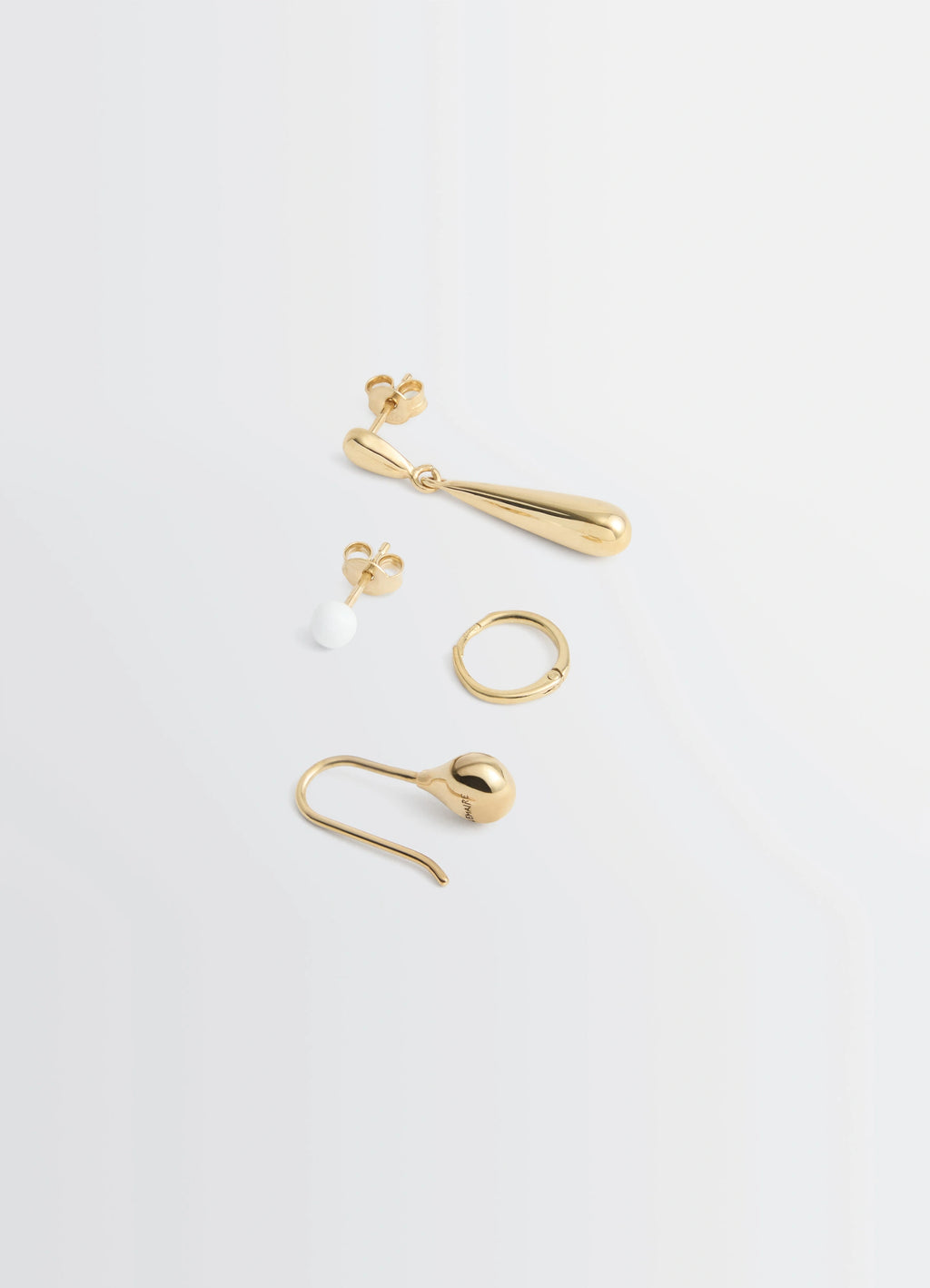 PIERCINGS SET in Gold-plated silver and resin, product shot, angled flat lay view assorted mixed shapes