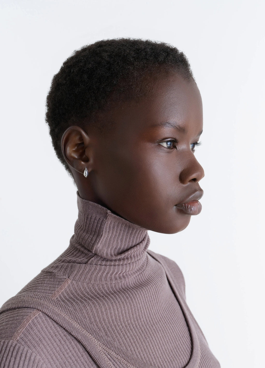 Lemaire Micro Drop Earrings in Rhodium-Plated Silver, model shot, side profile view worn with ribbed turtleneck
