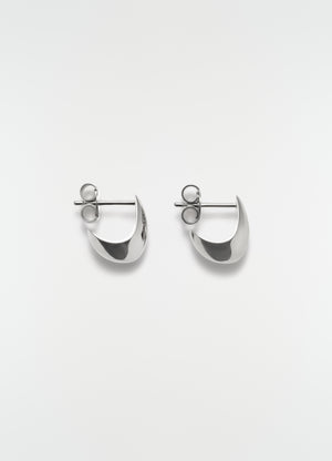 Micro drop silver metal earrings by lemaire flat lay on white background showing front detail