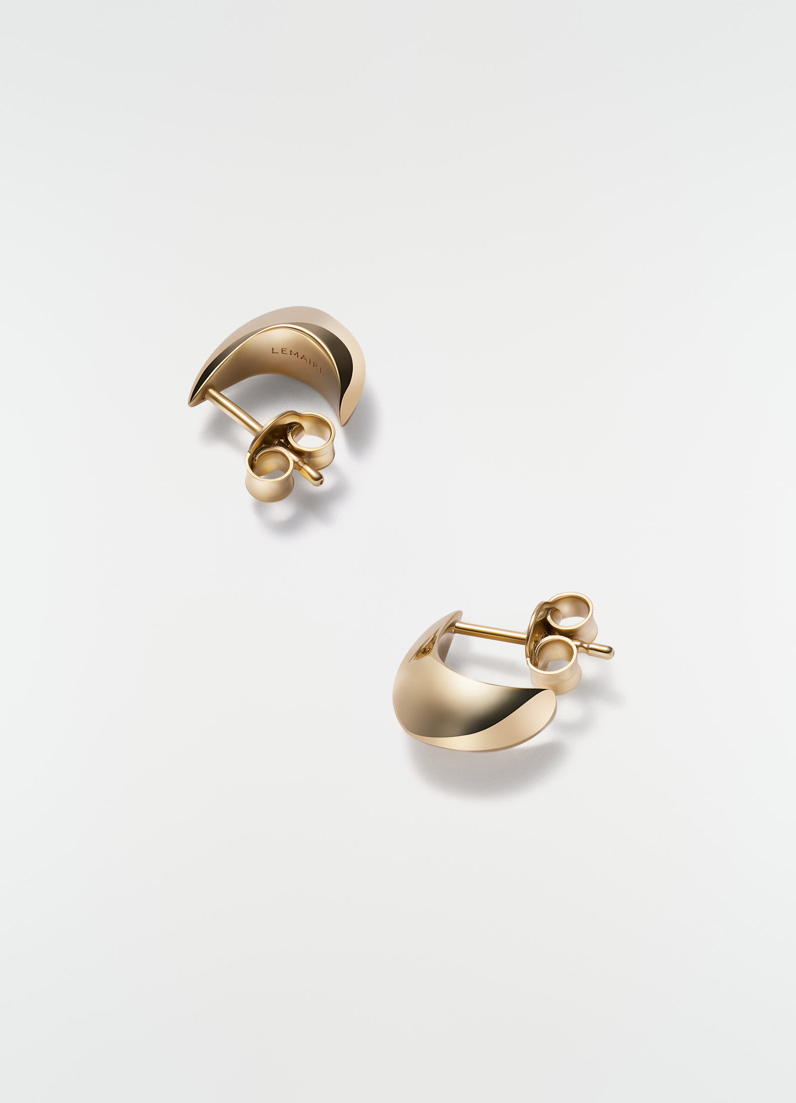 Micro drop gold-tone metal micro drop earrings by lemaire on plain white background close-up detail
