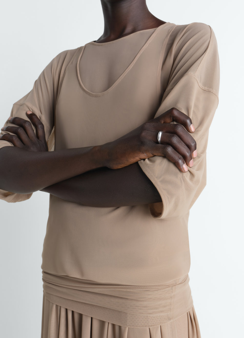 Drop ring in vermeil worn by model with beige LEMAIRE sheer mesh top close-up detail