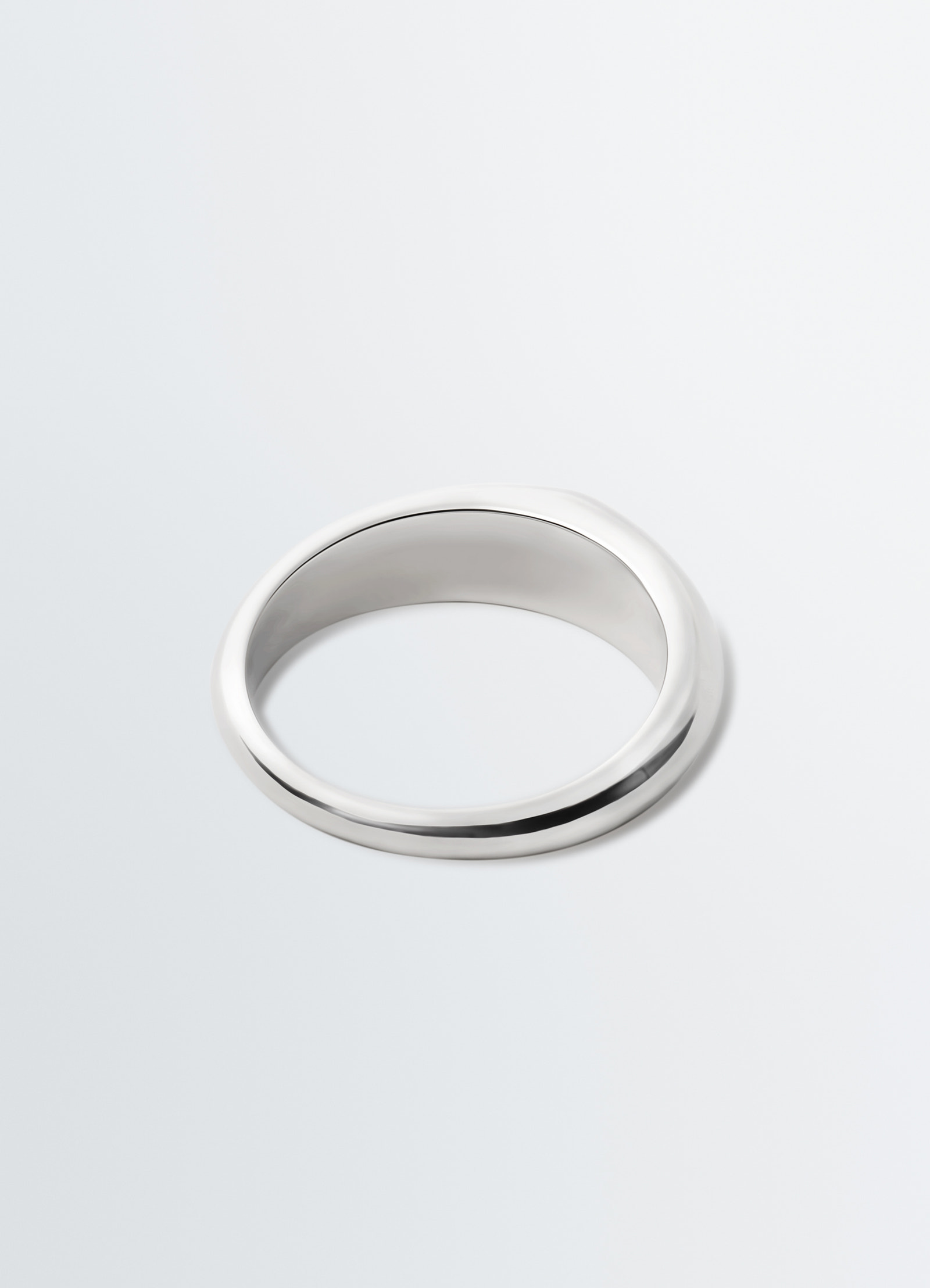 Drop ring in silver metal by lemaire on plain white background, showing smooth polished surface.