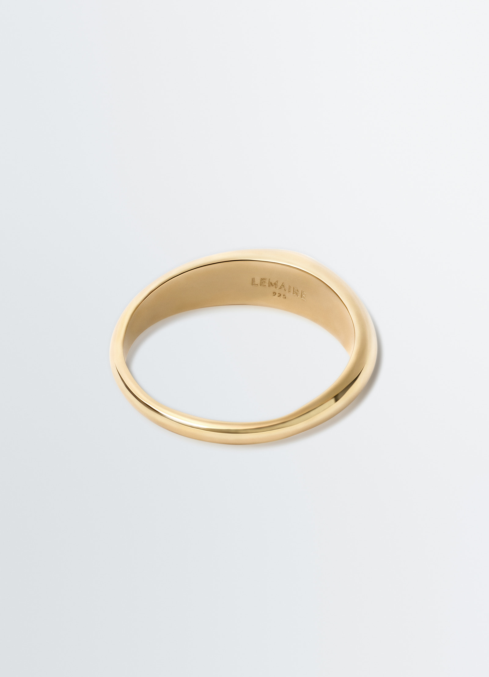 Drop ring in gold vermeil metal by lemaire flat lay on white background showing inside engraving detail