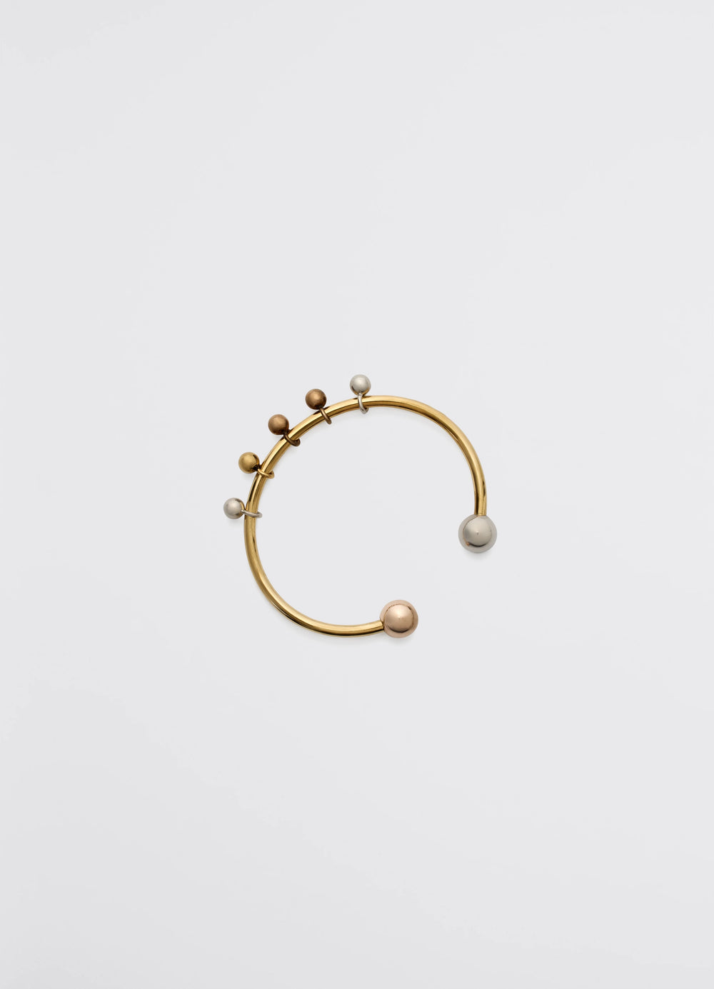 Lemaire Rattle Cuff in Brass with silver, copper and gold, product shot, side view circular open design