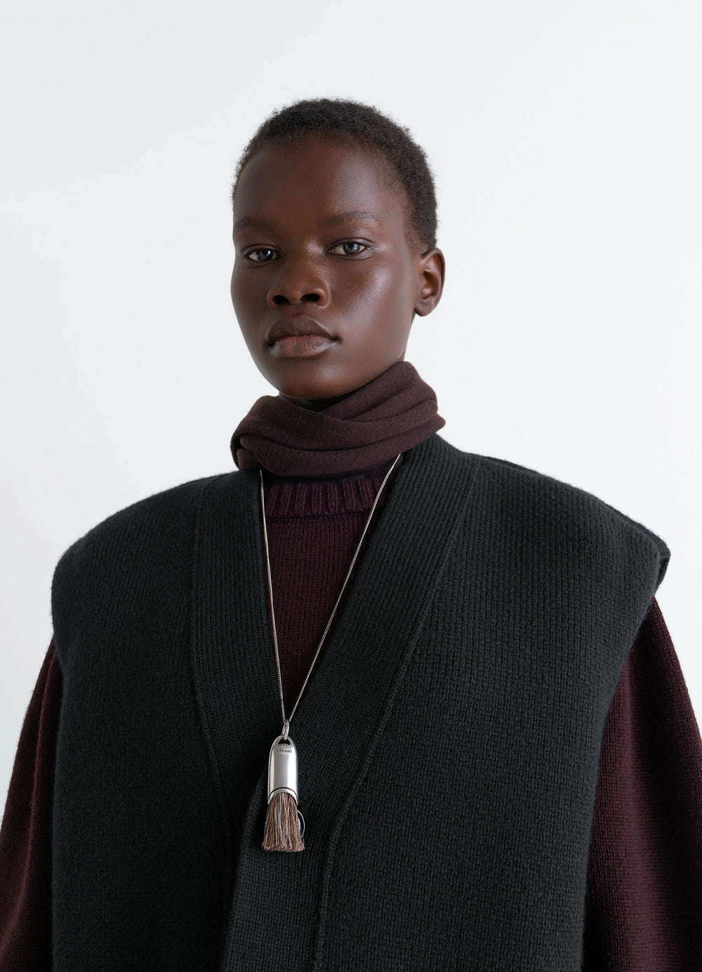 Lemaire Personal Brush Necklace in Silver and Brown Brush, model shot, porte upper body view worn over dark clothing