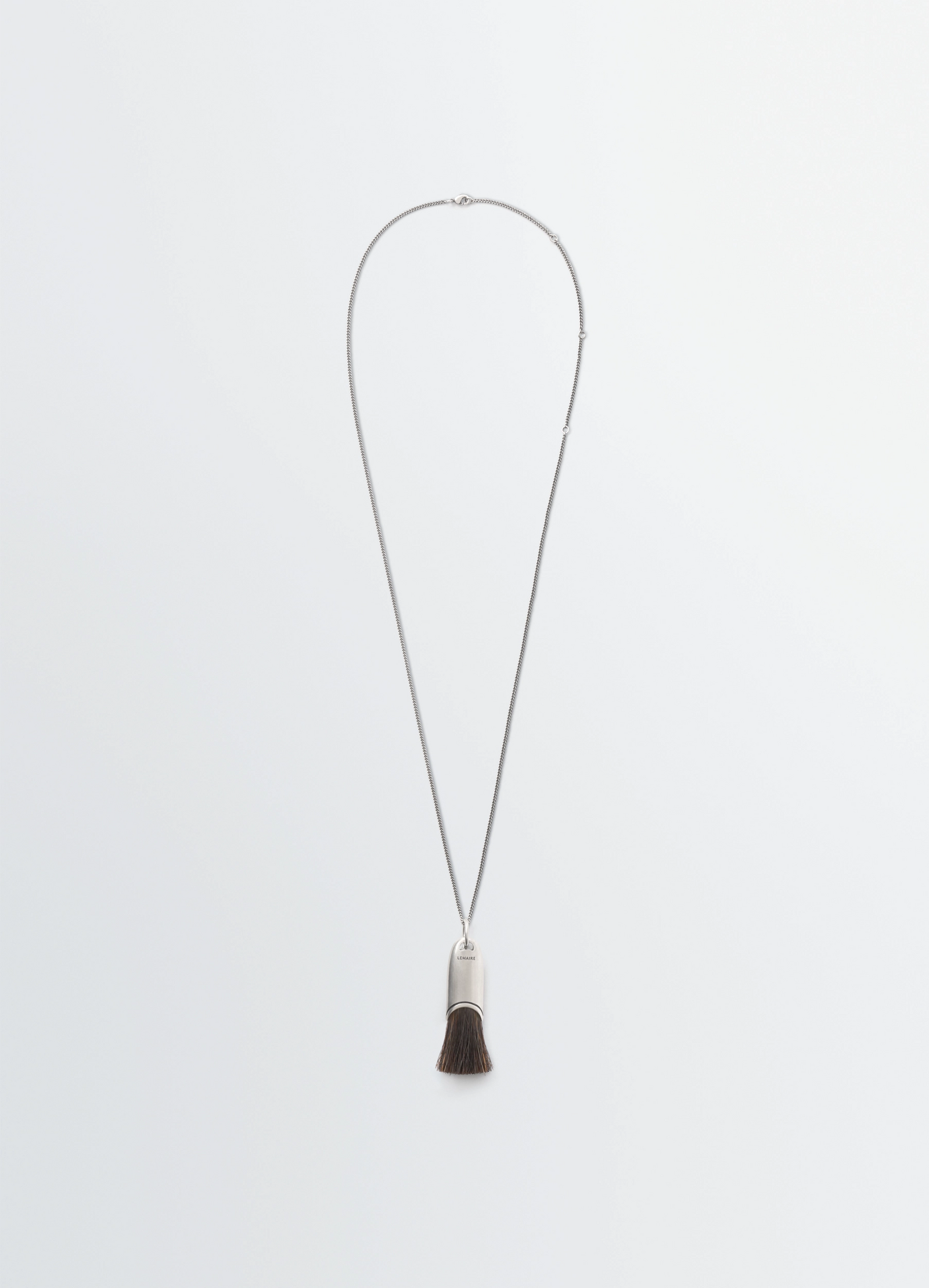 Lemaire personal brush necklace in silver chain with brush pendant, product shot, front view minimalist design
