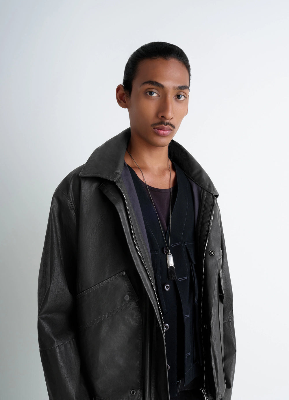 Lemaire Personal Brush Necklace in Silver and Dark Brush, model shot, three-quarter view necklace worn over clothing