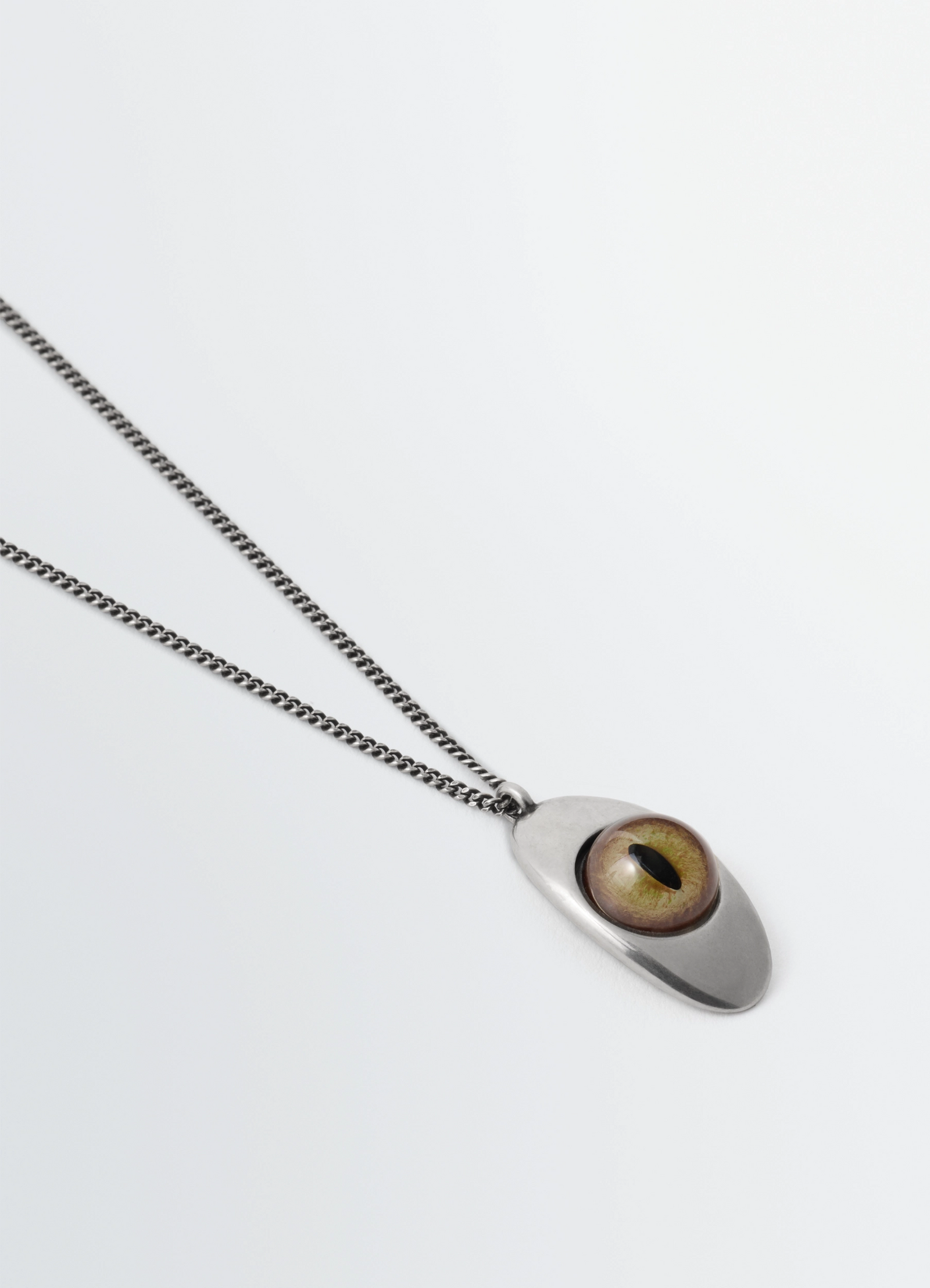 Cat eye pendant necklace in silver-plated brass, product shot, angled top view smooth chain detail