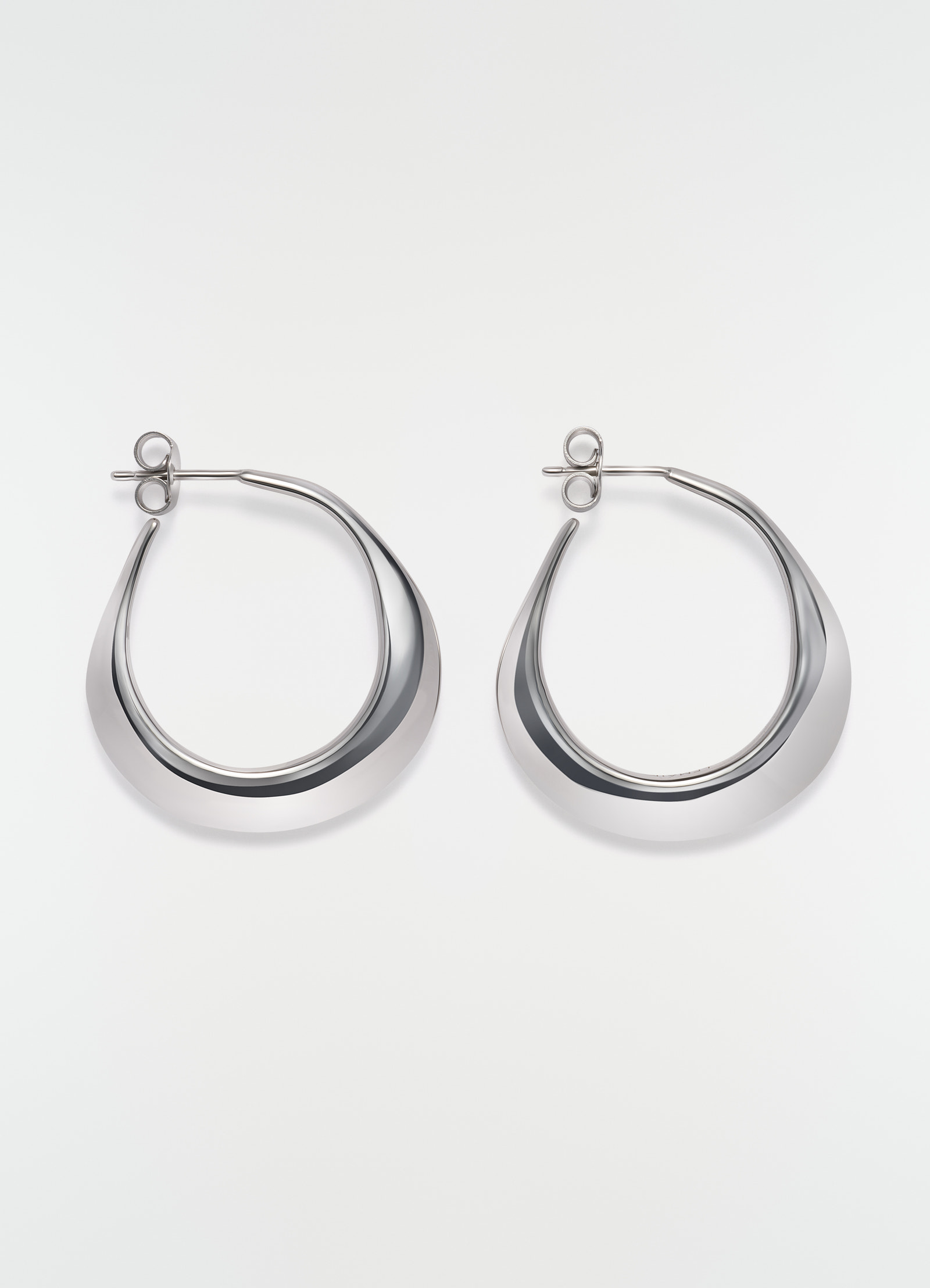 Hoops drop earrings in silver metal by lemaire flat lay on white background showing front view