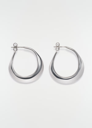 Hoops drop earrings in silver metal by lemaire flat lay on white background showing front view