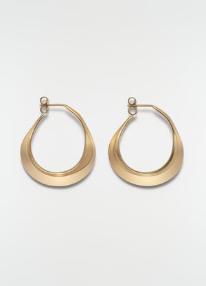 Drop hoop earrings in gold vermeil metal by lemaire on plain white background, front view.