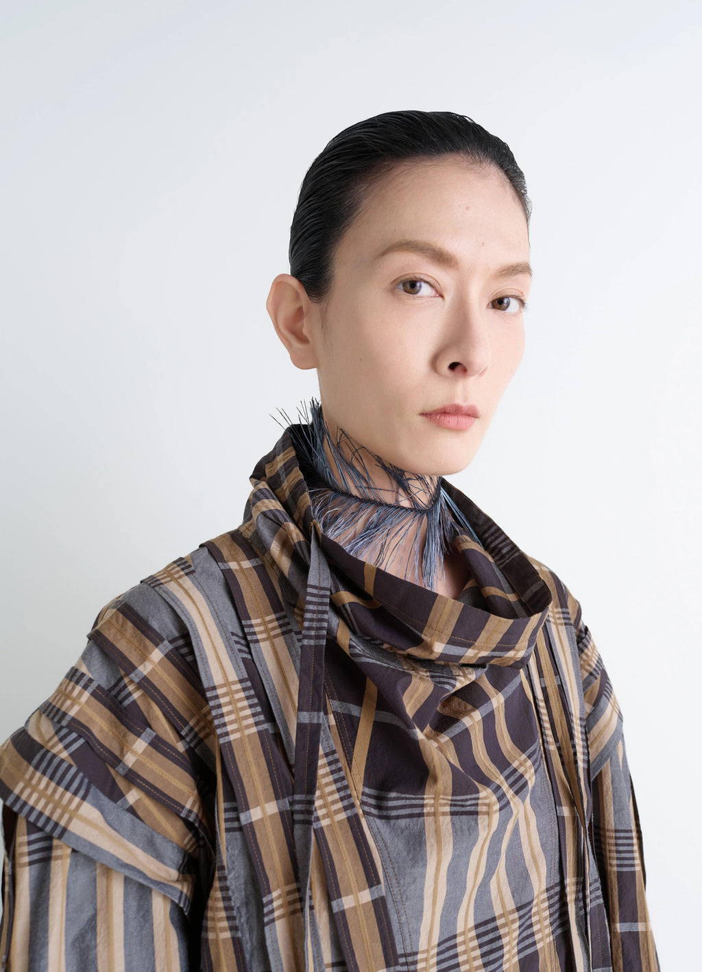 Feather Necklace in Dyed Ostrich Feathers, Silver-Plate, model shot, side profile view worn with plaid garment