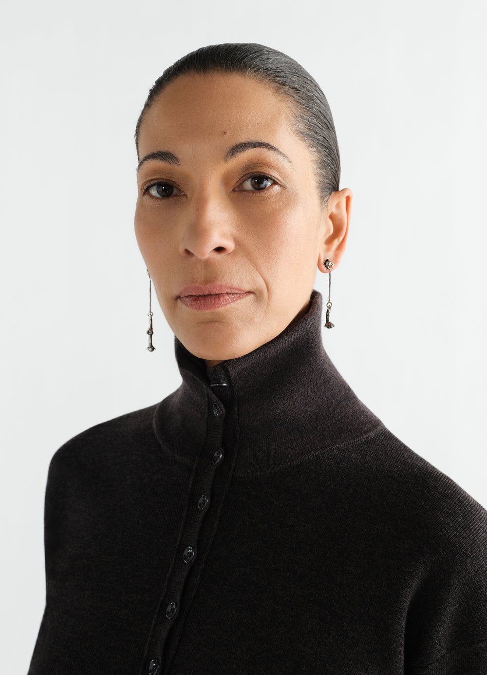 Clove pendant earrings in silver worn by a model in a close-up front shot LEMAIRE