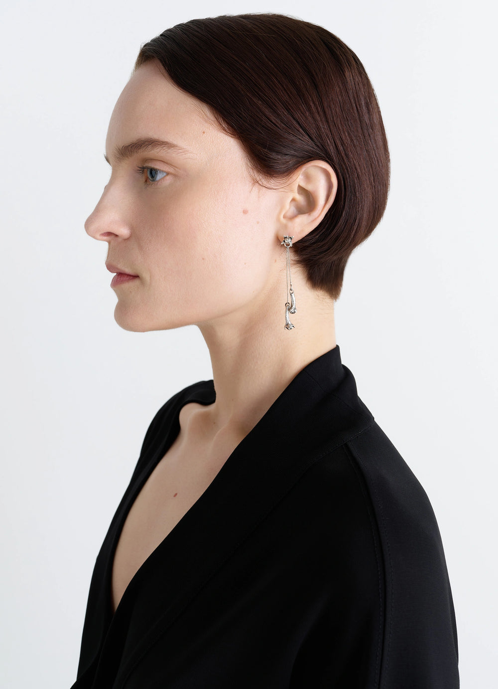 Clove Pendant Earrings in Hammered Patinated Brass, model shot, side view worn by model