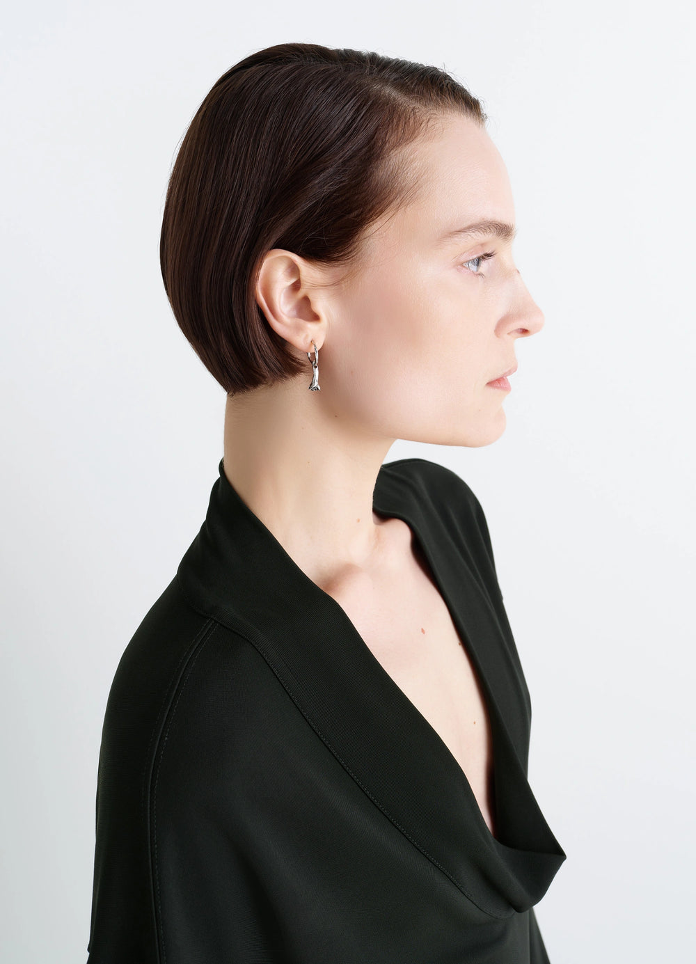 Clove Earrings in Hammered Patinated Brass, model shot, three-quarter view worn with sleek bob