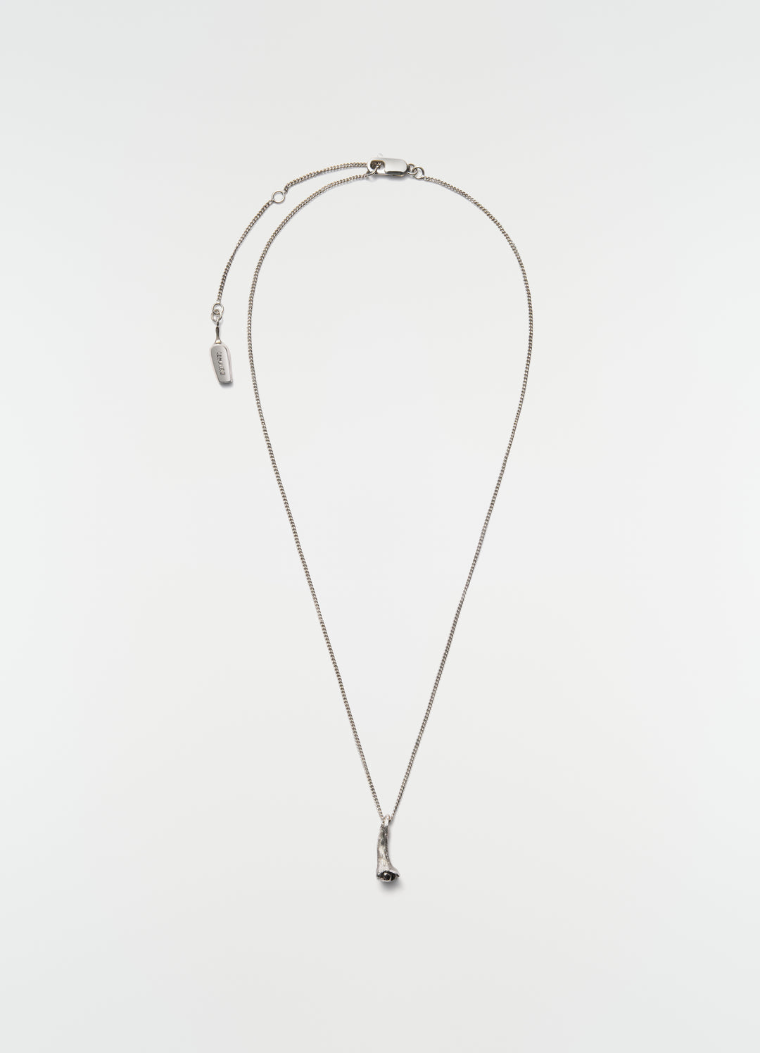 Silver metal clove necklace by LEMAIRE with fine chain and lobster clasp on plain white background