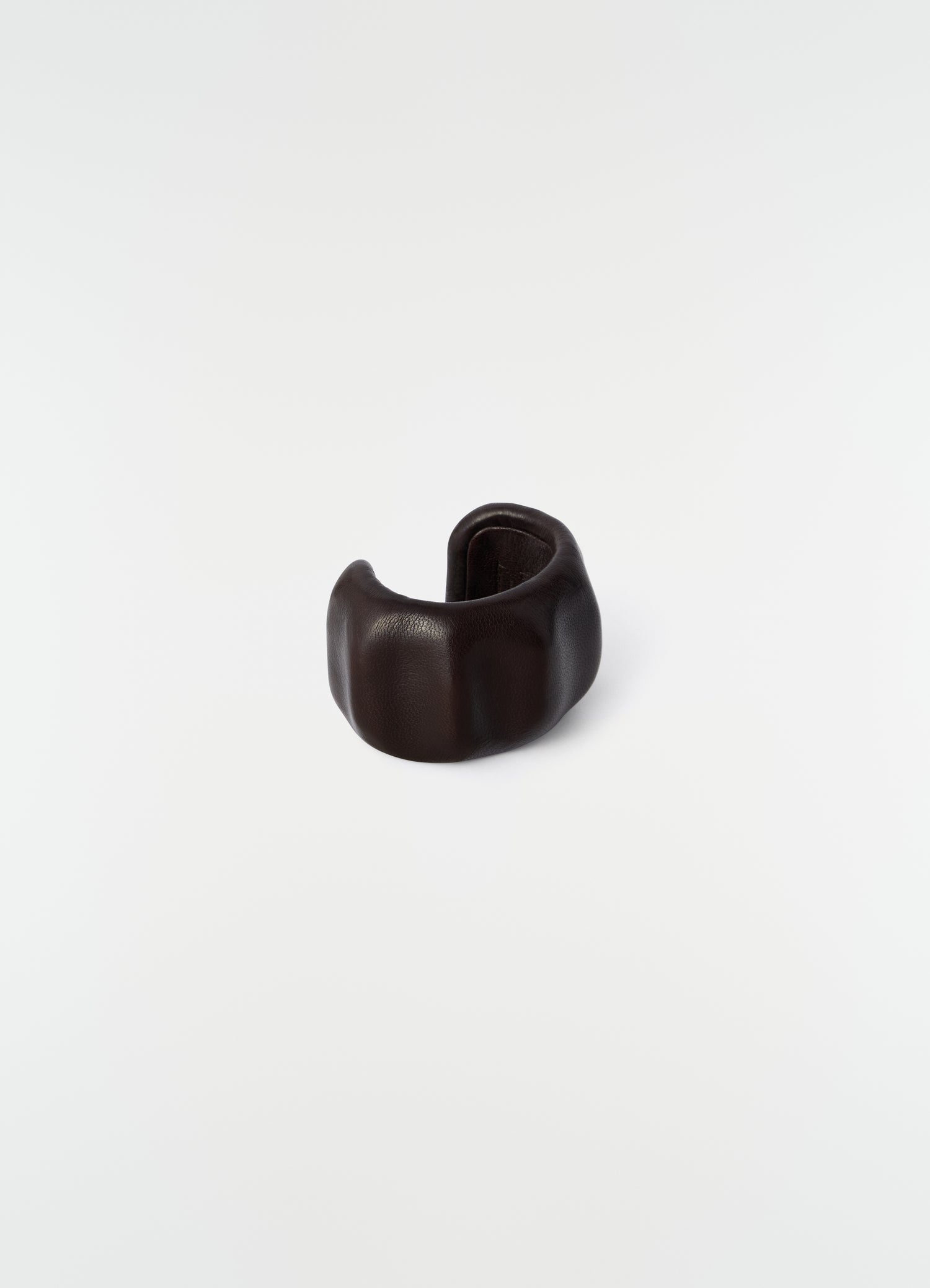 Carlos cuff in dark brown leather LEMAIRE close-up detail on plain white background