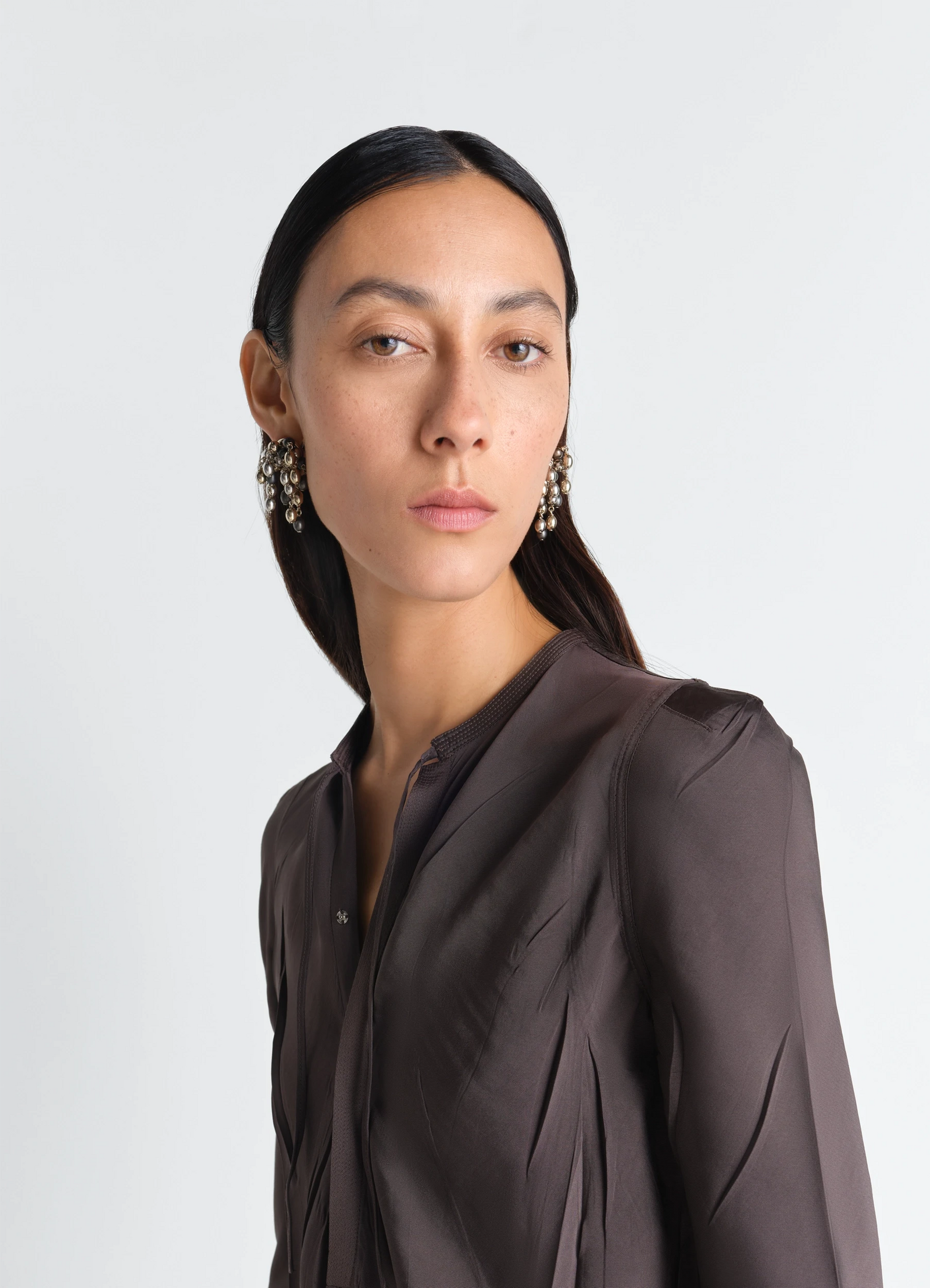 Seeds earrings in gold and silver tones, model shot, three-quarter view dangling beads