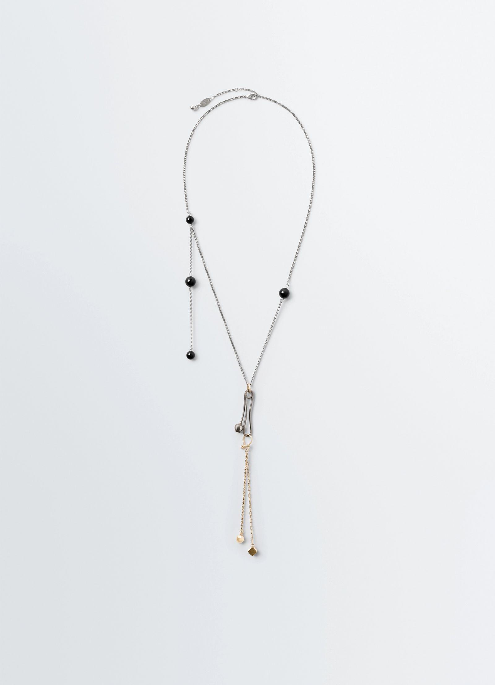 Thistle necklace in silver and gold metal, product shot, front view delicate thistle form