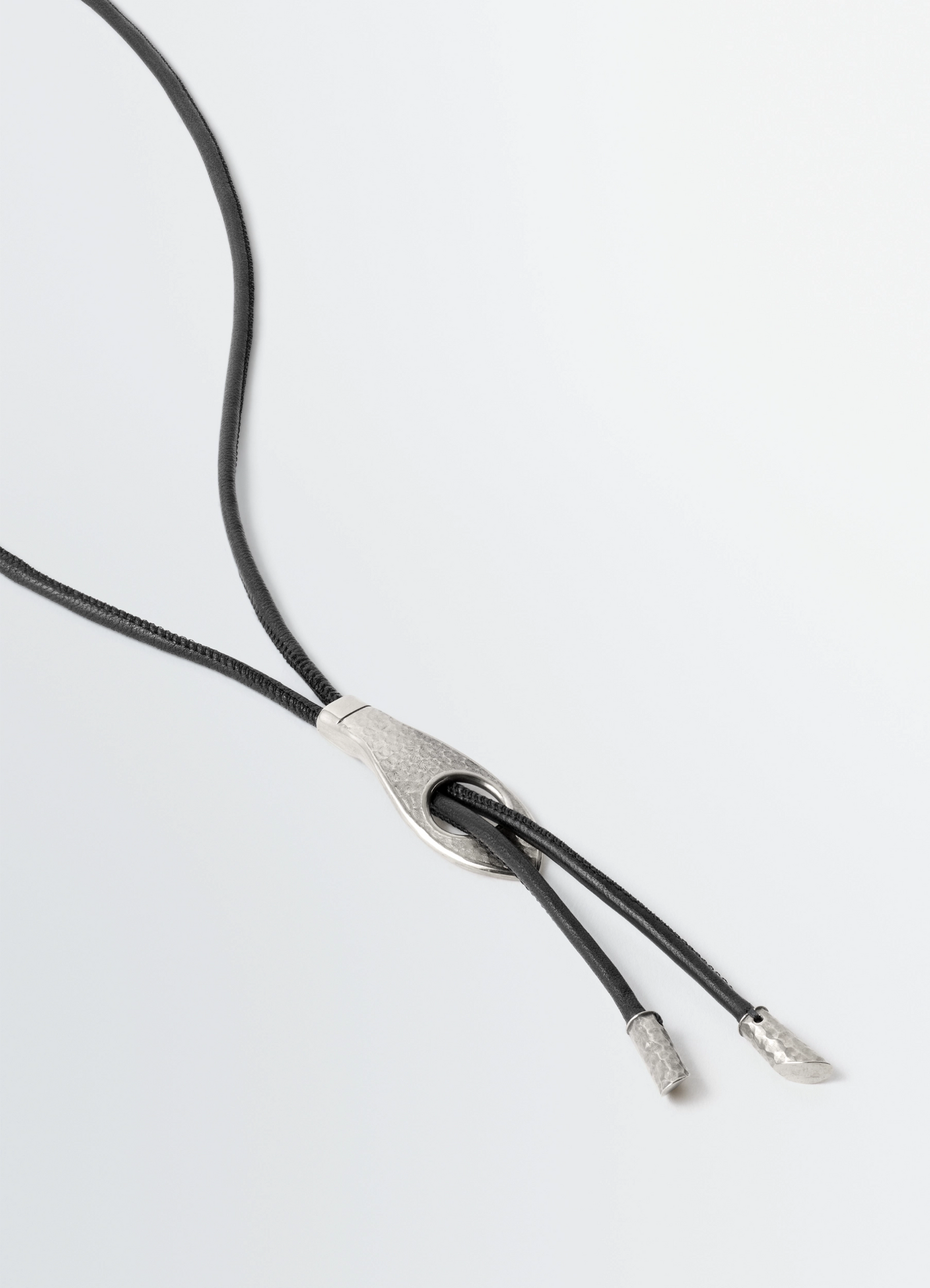 Snake bolo tie necklace in leather and brass, product shot, angled closeup intricate knot detail